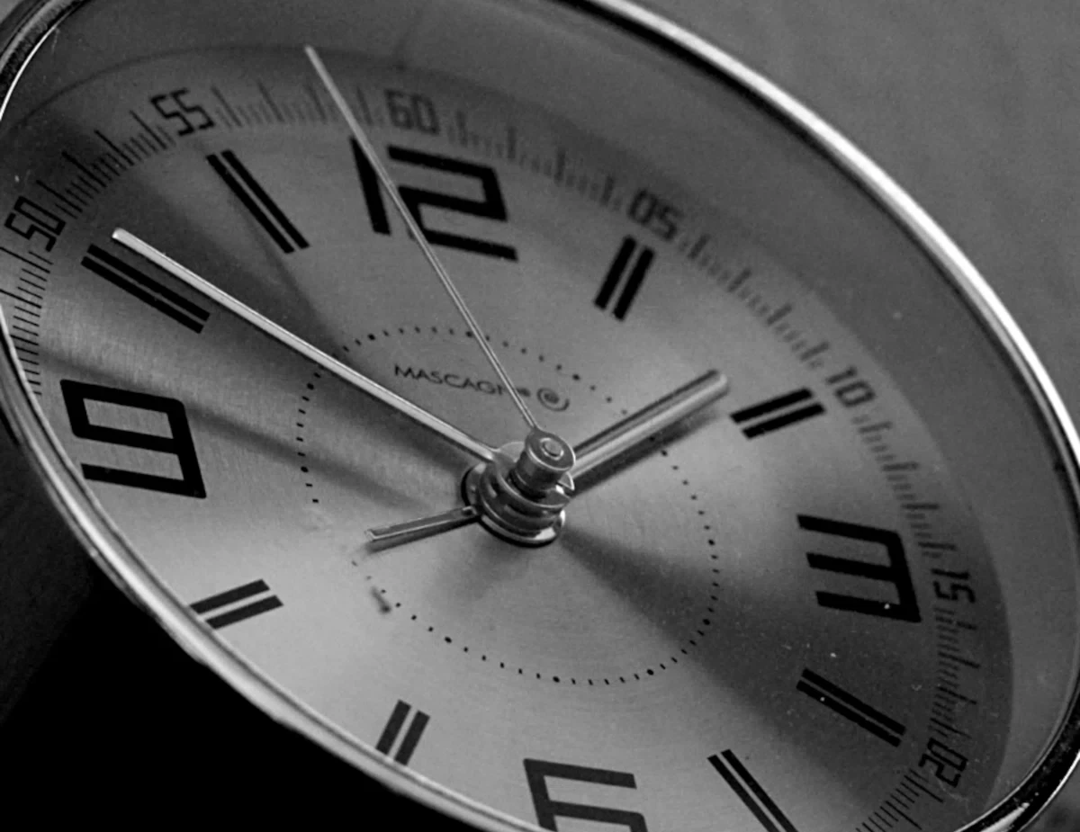 a black and white photo of a clock