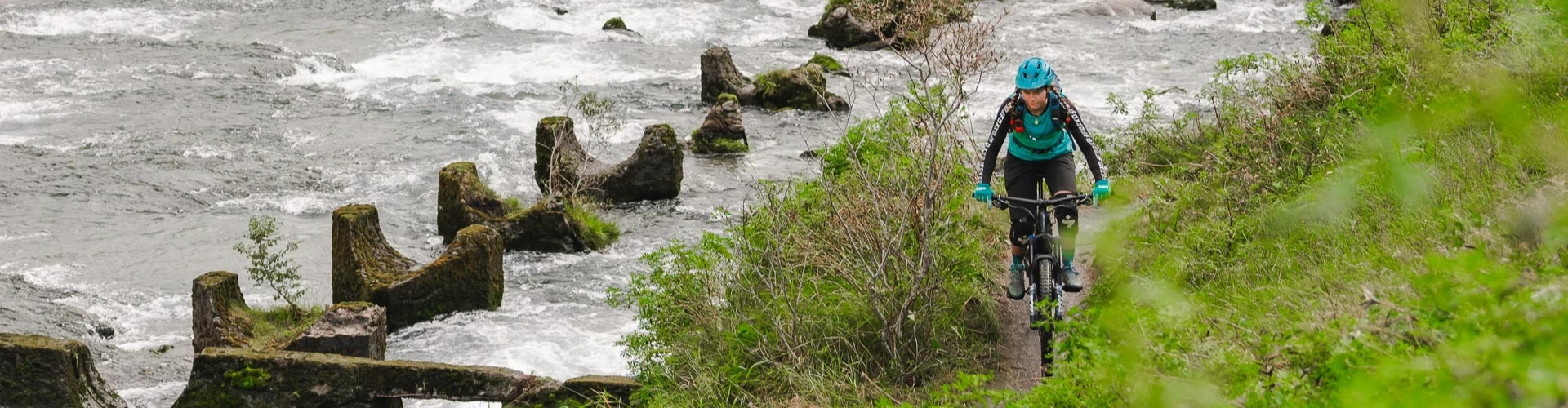 a woman rides mtb by a rider