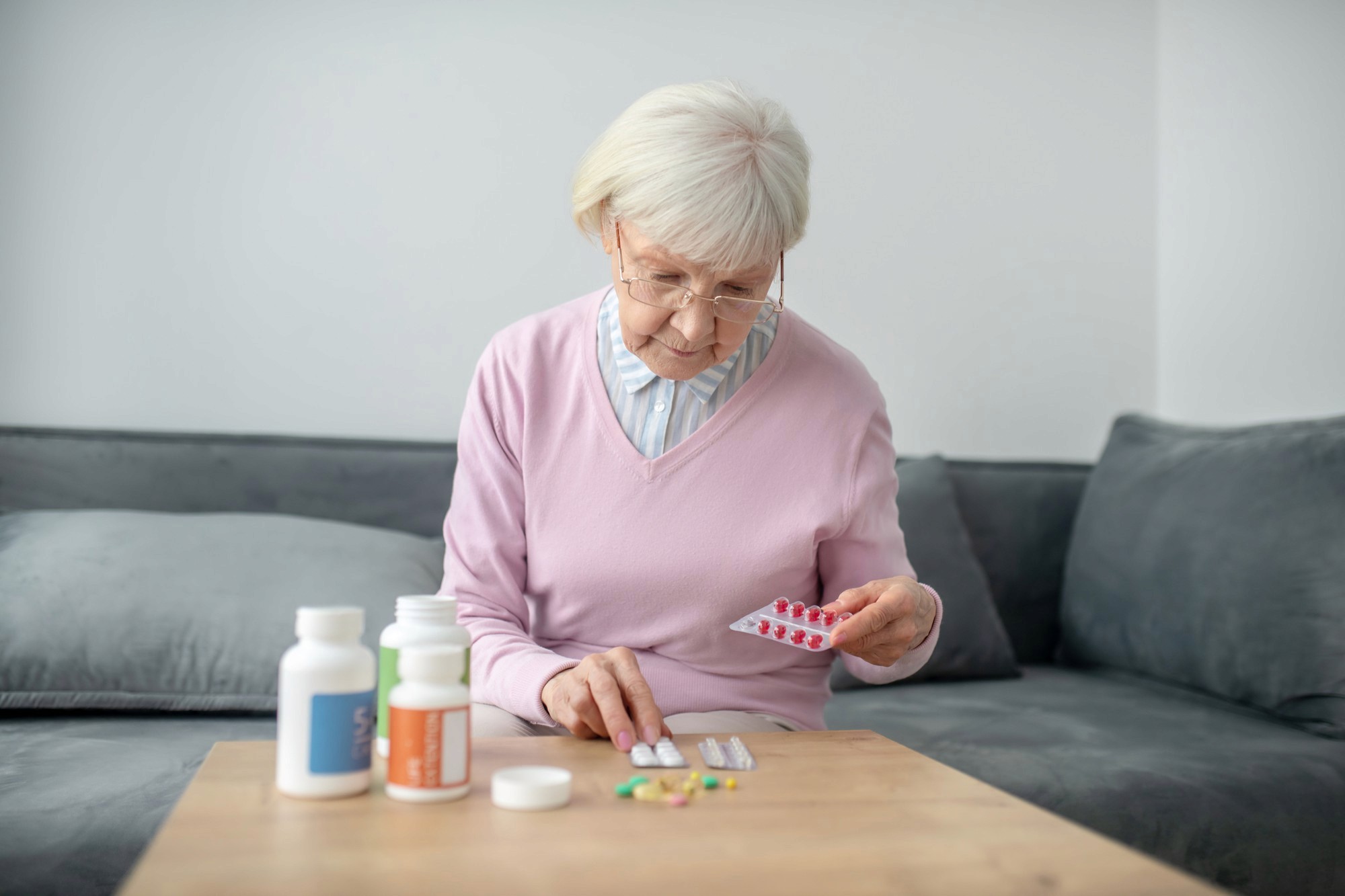 Older adult managing multiple prescription medications at home