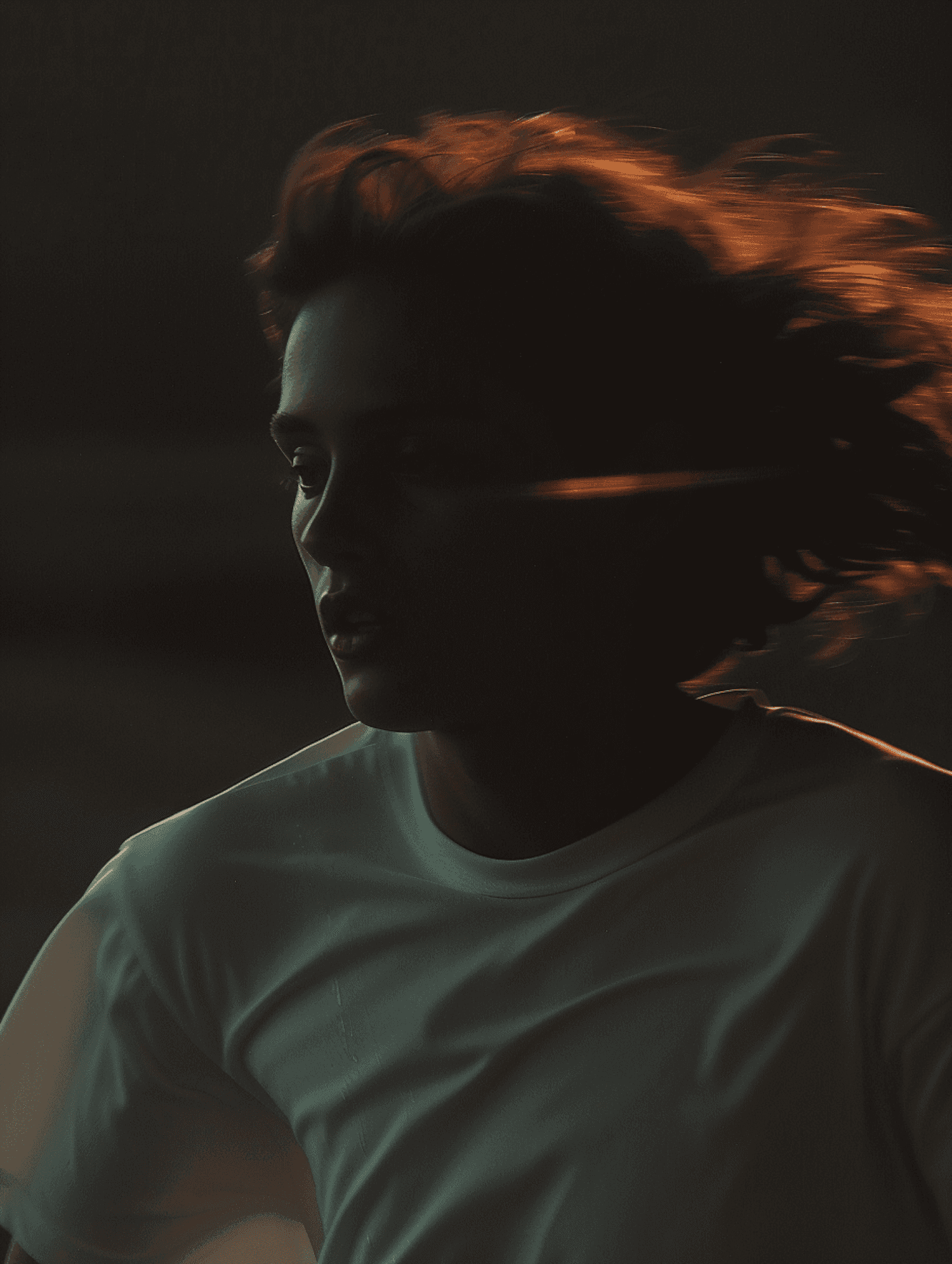 Close portrait in warm sunset light with windblown hair