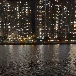 hong kong cityscape at night next to river with lights