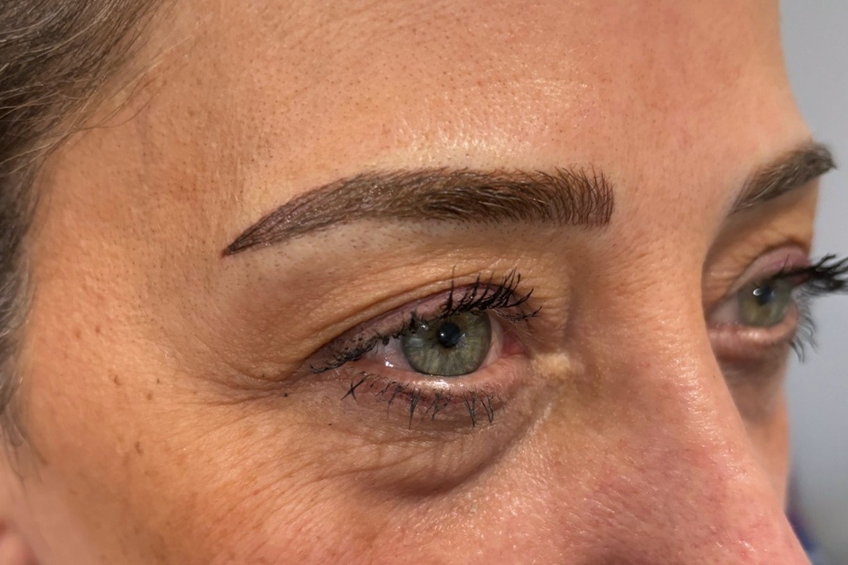 Close-up of a freshly microbladed eyebrow, showing fine hair-like strokes and natural brow enhancement.