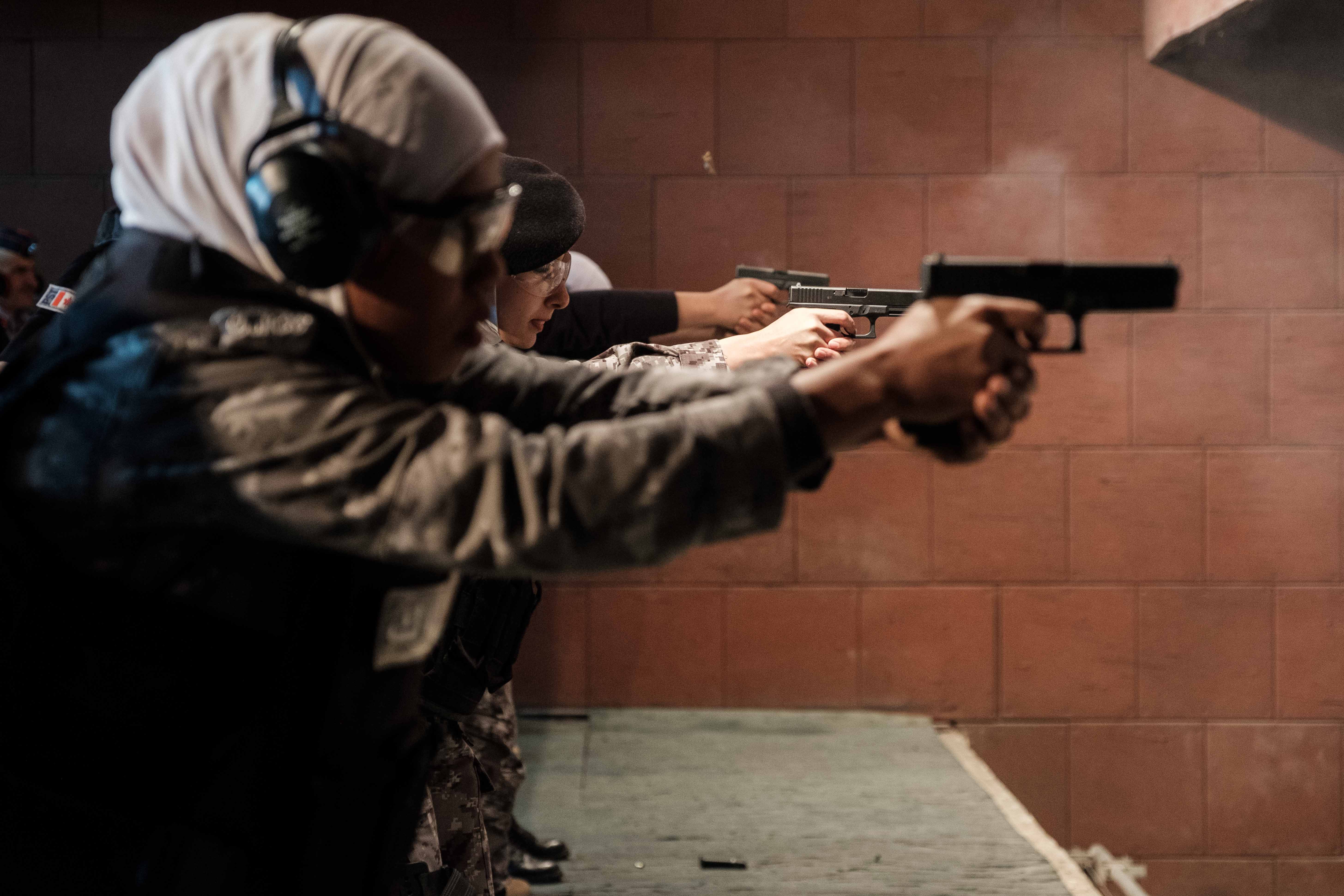 Women police practice in a shooting range