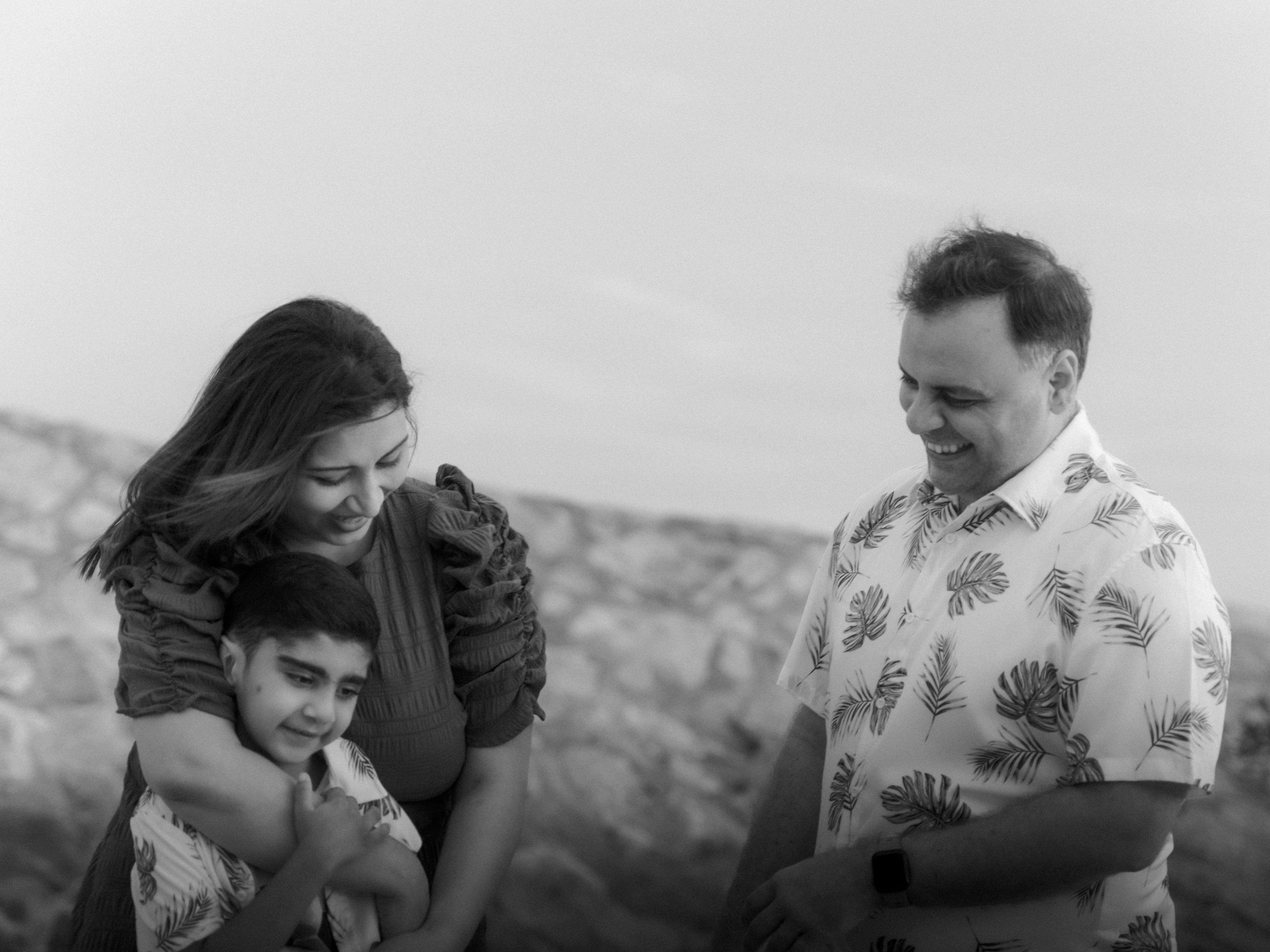 Young family portrait: Couple with their toddler son playing by the shore at East Coast Park.
