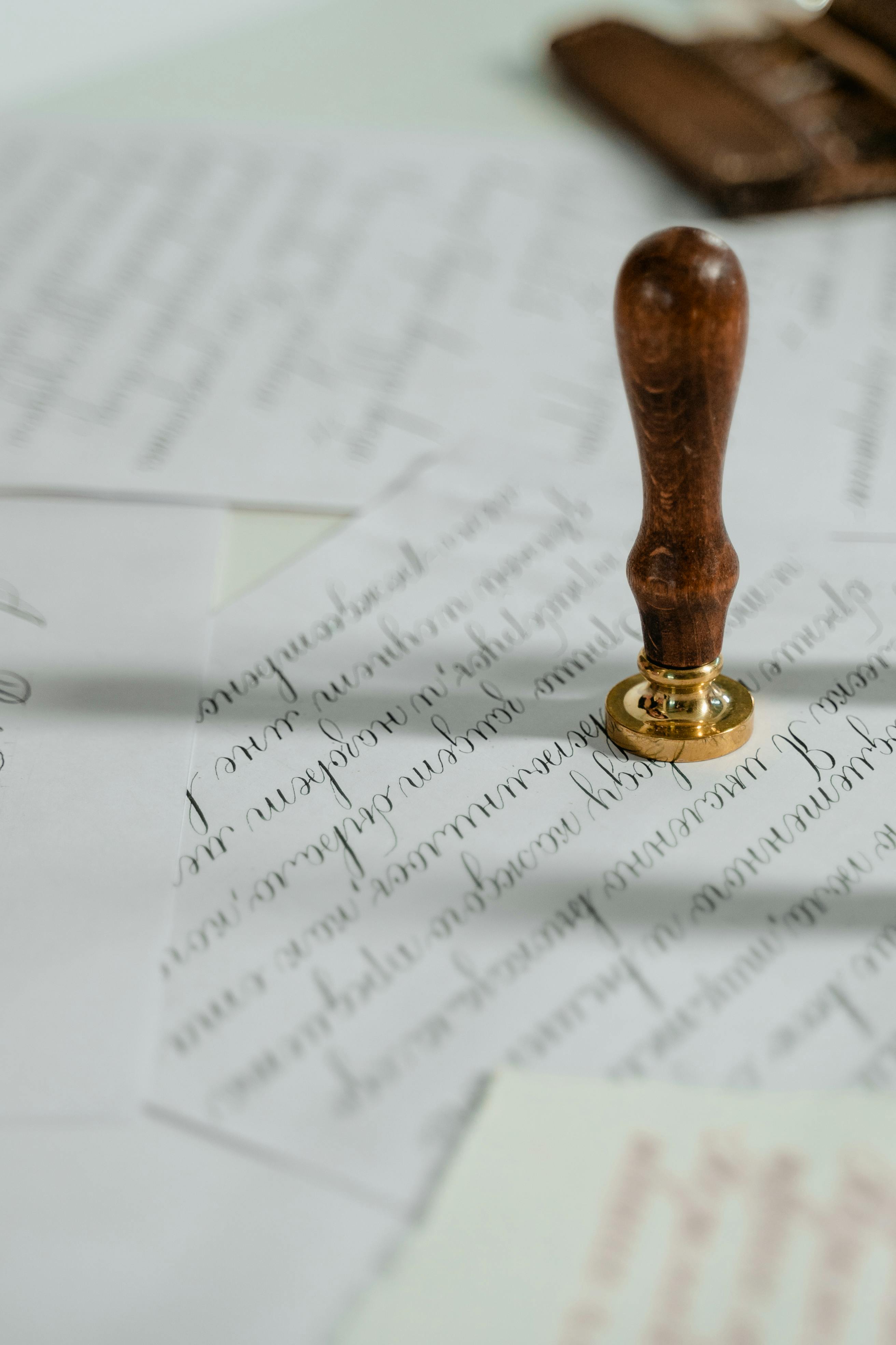 vintage-calligraphy-papers-with-a-wooden-wax-seal-stamp,-embodying-timeless-eleg - mart-production (pexels)