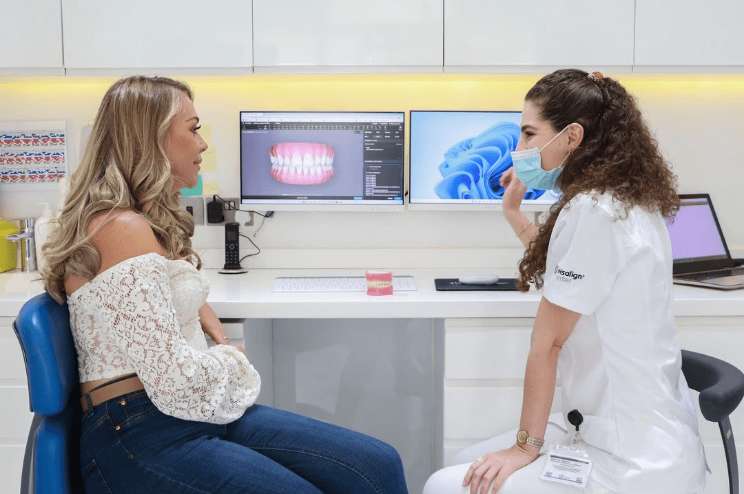 Diamond-awarded dentist showcasing advanced veneer treatment technology to a client.