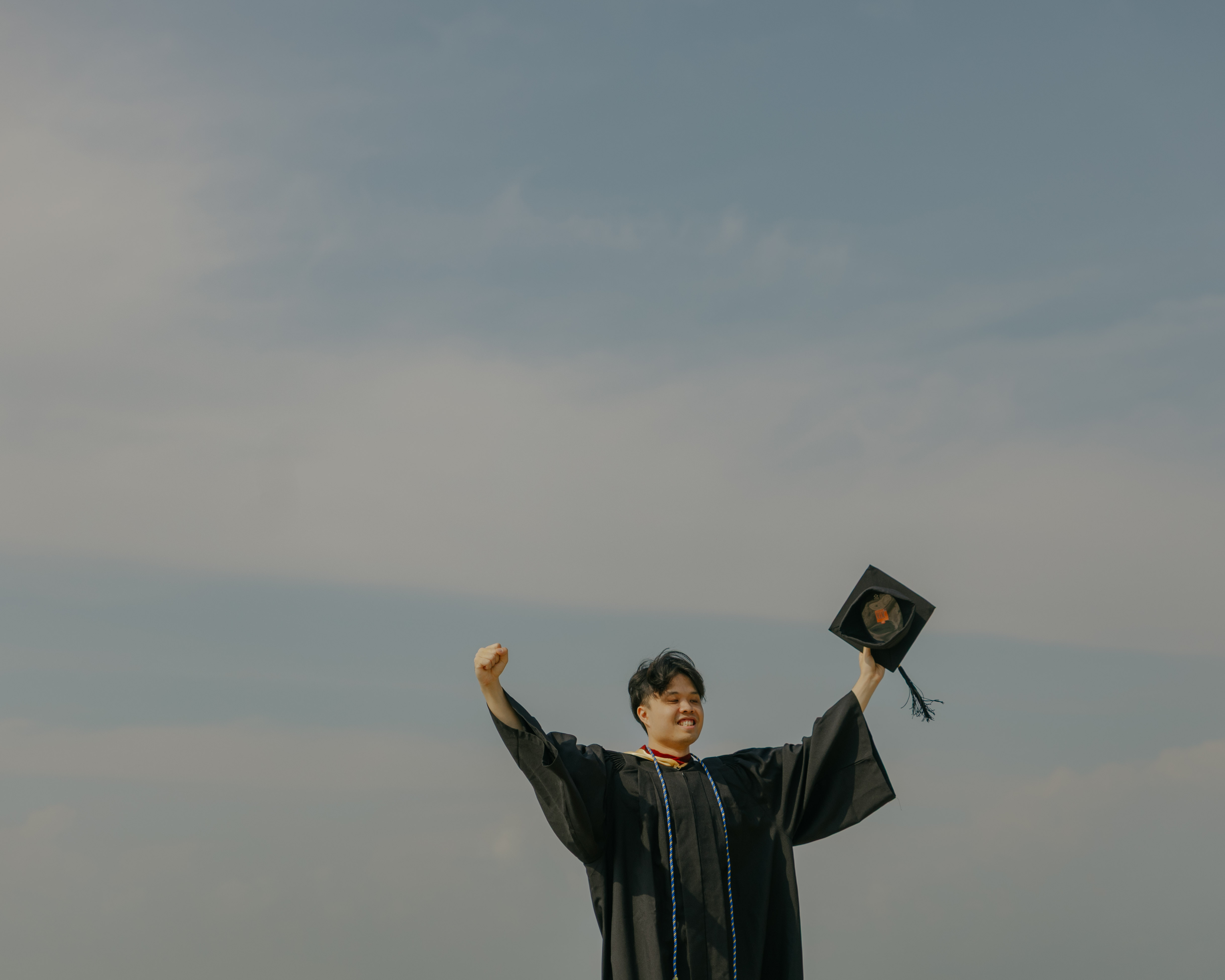 Graduation family portrait photography in Singapore by the beach.