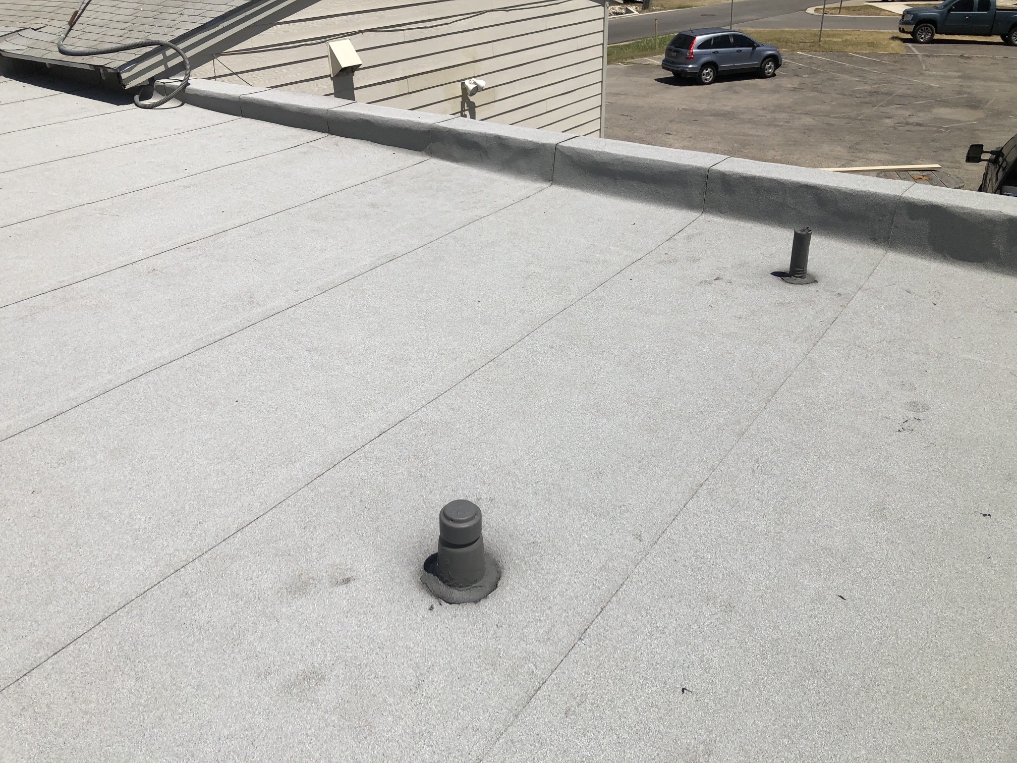 Completed modified-bitumen roof at Buda VFW, 2021. The finished surface alone cannot confirm the hidden ply count.