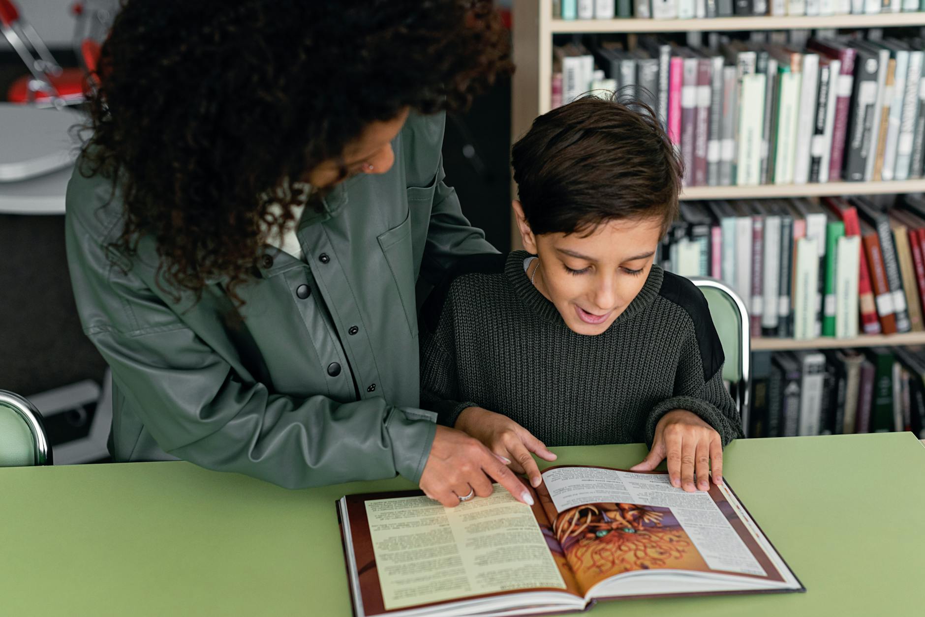 A middle school teacher reviewing a shelf of diverse children's books to assess representation in the classroom.