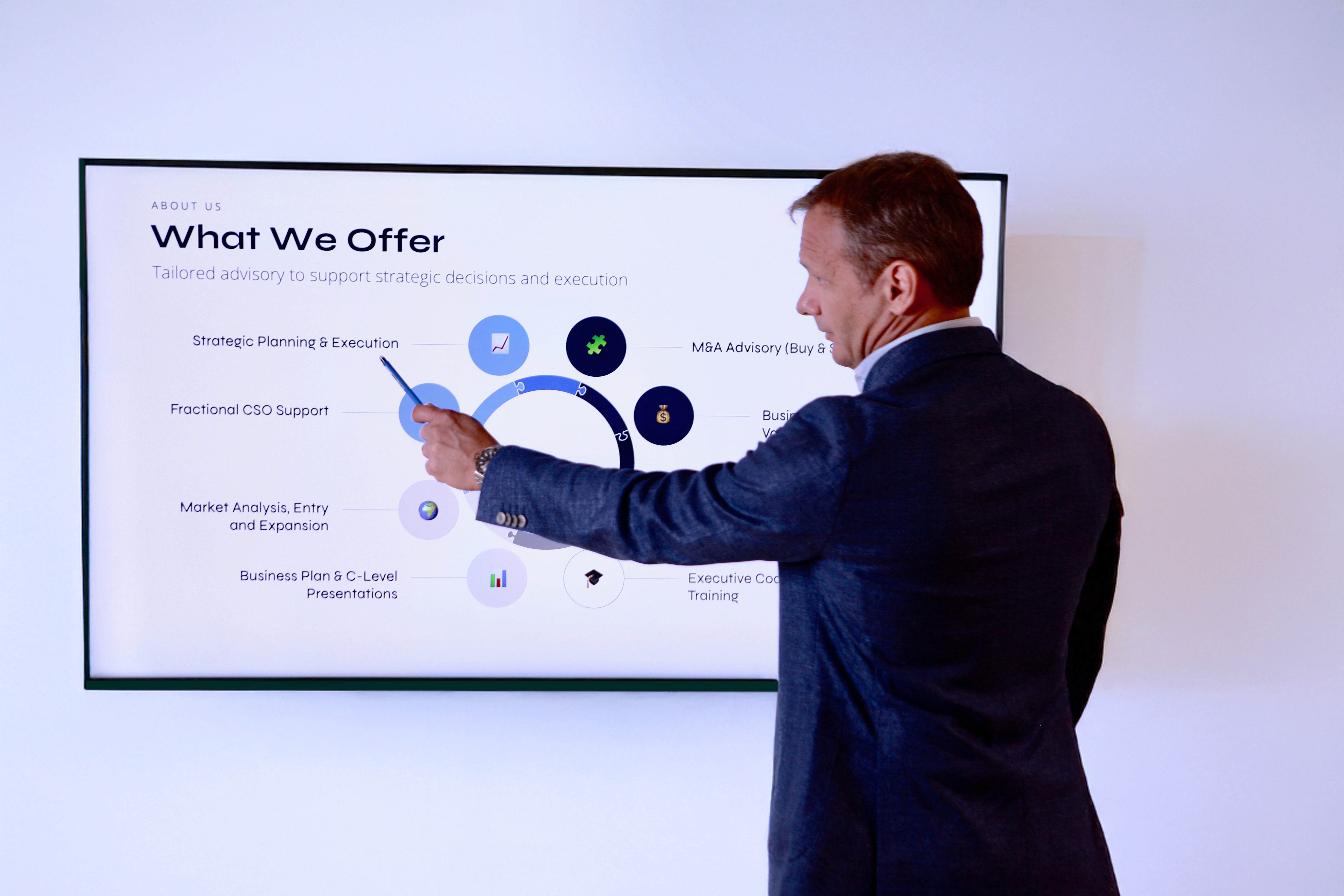 A man in a white lab coat working at a computer, viewing a 3D model on the screen in a laboratory or office setting.