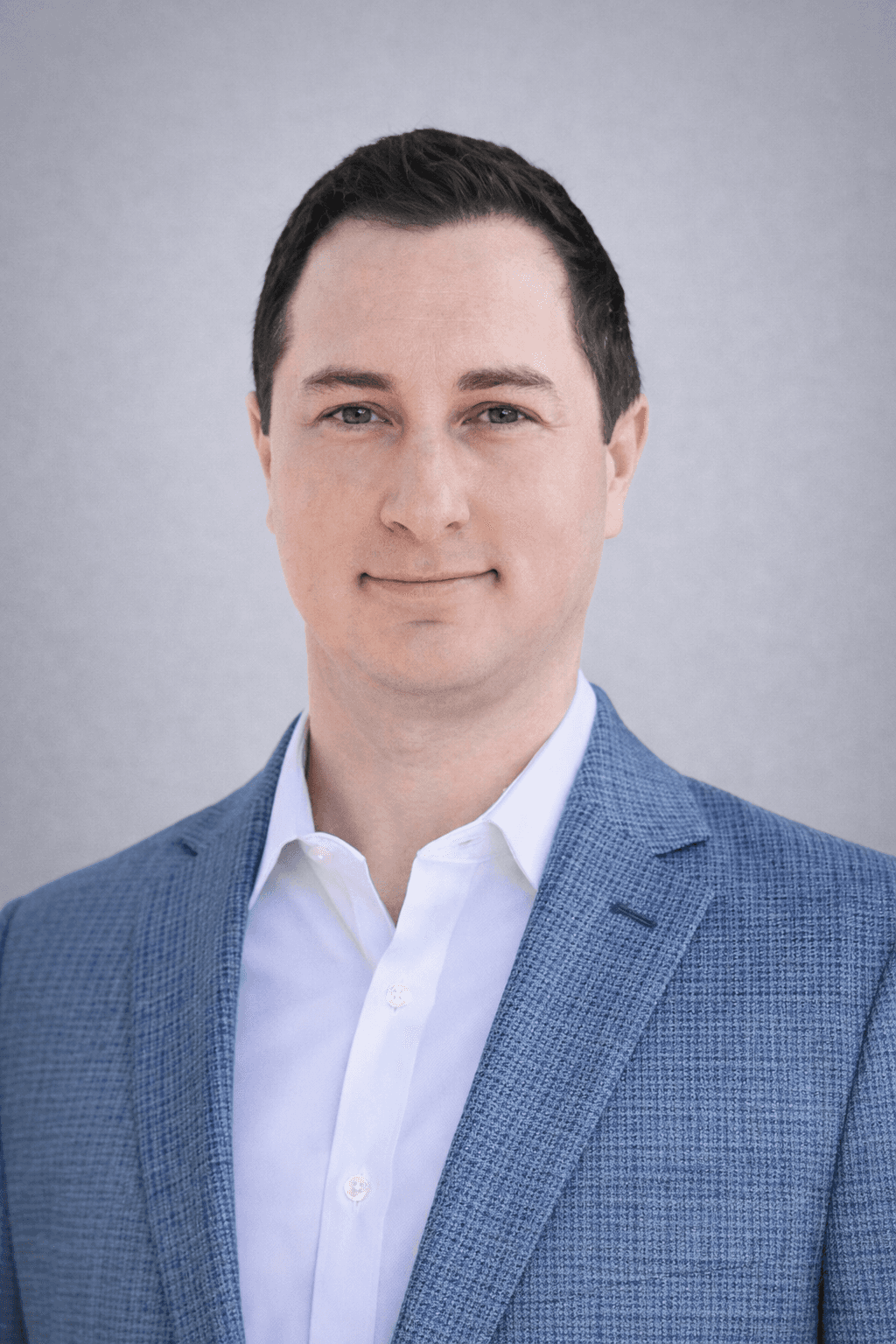 Black and white portrait of a smiling person with curly hair