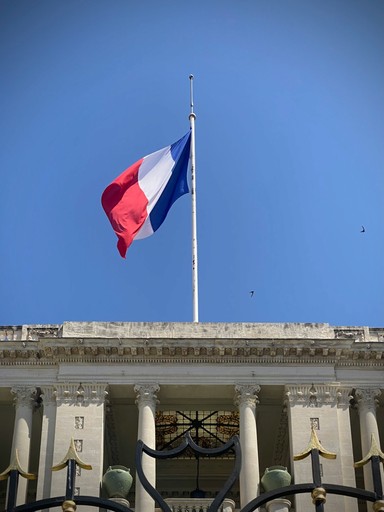 a french flag on an administrative building, representing the french bureaucracy