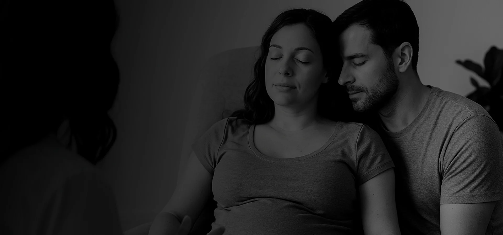 Pregnany woman and her husband breatghing and meditating together