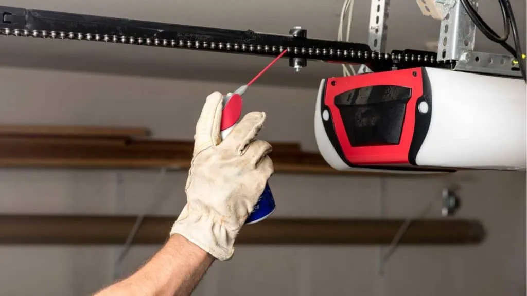 Garage door repair Rio Rancho: lubricating opener chain for smooth operation.