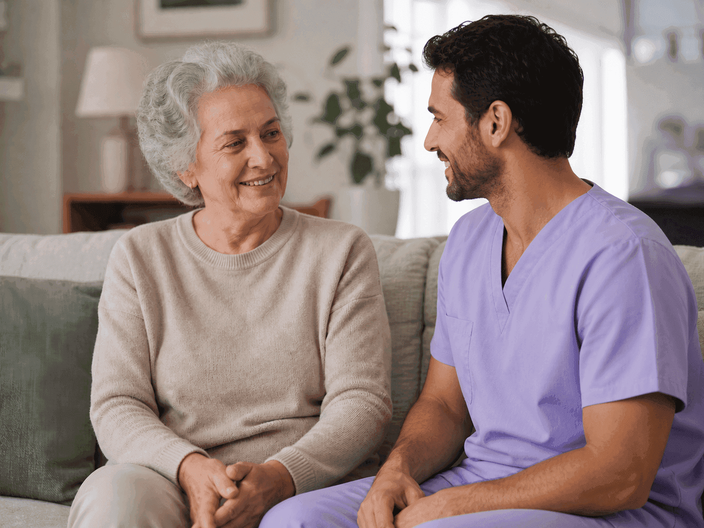 Caregiver offering thoughtful support to an elderly client during a daily routine
