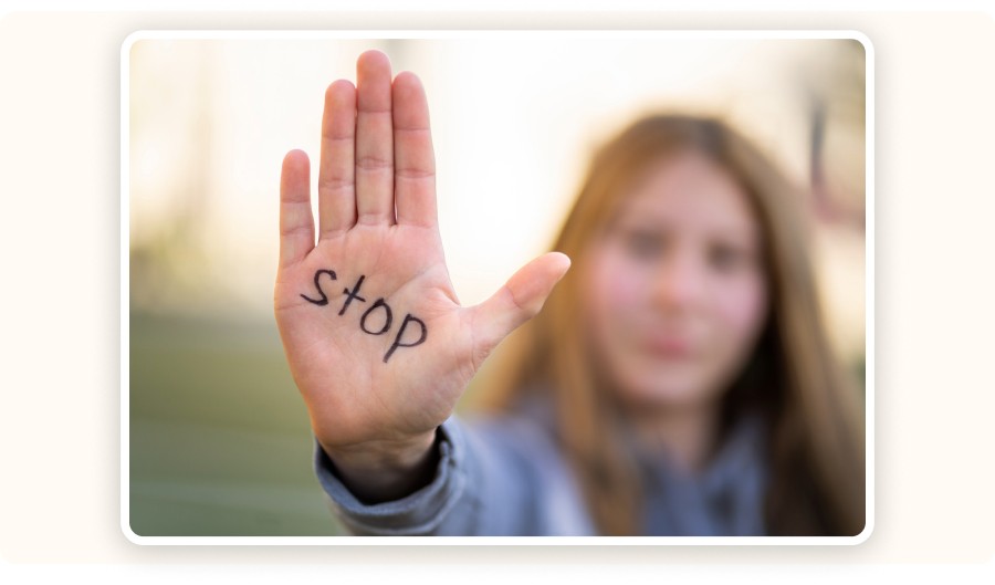Woman raising her hand with the word “stop”