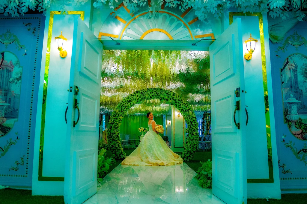 Bride walking through the golden sunburst doors of Celestia Hall, Stalla Suites Events Place QC