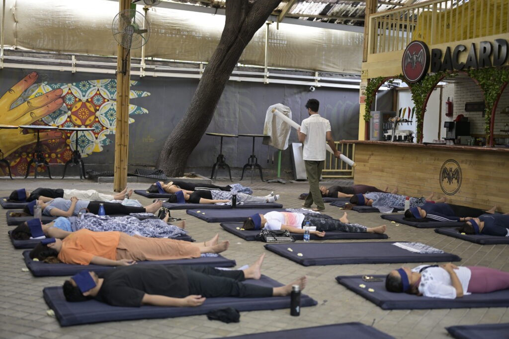 Participants resting during an immersive sound meditation and corporate wellness session in Pune