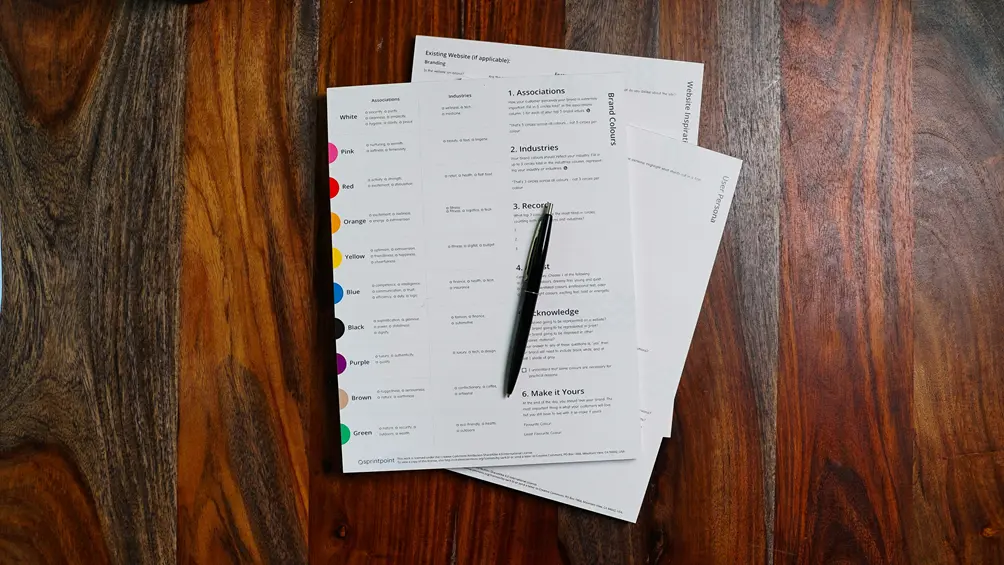 Business sale paperwork and pen on a wooden desk