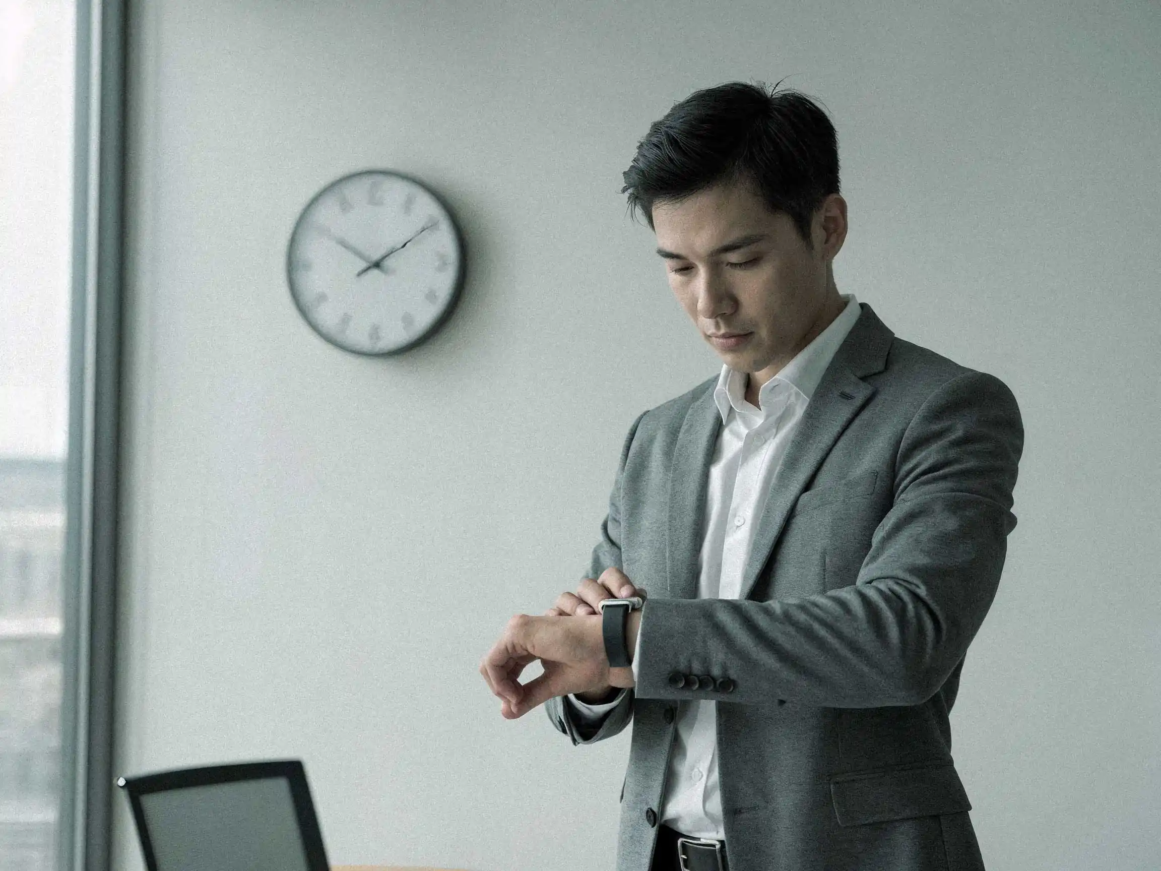 Business professional checking time in a modern office