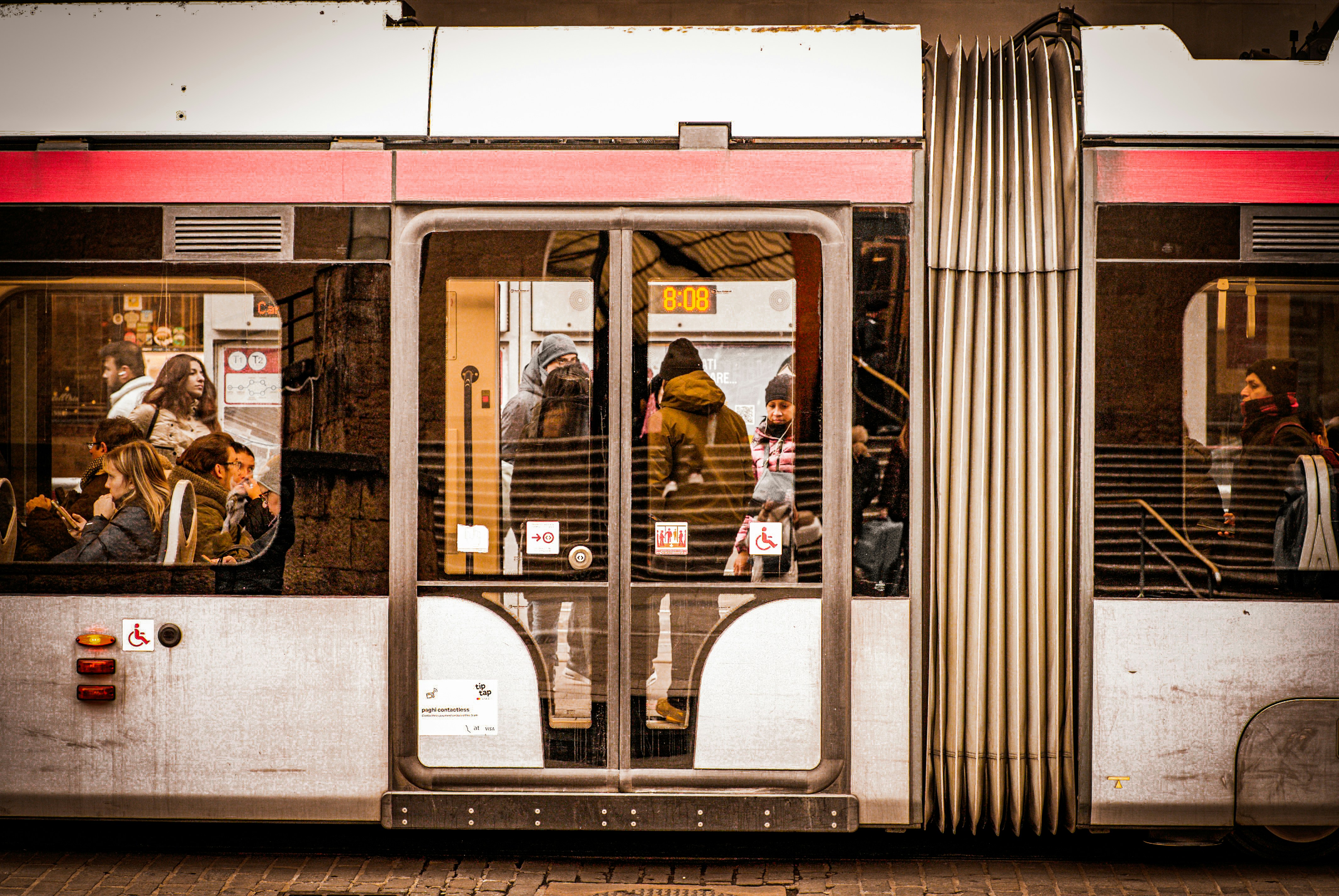 A subway car with people inside of it