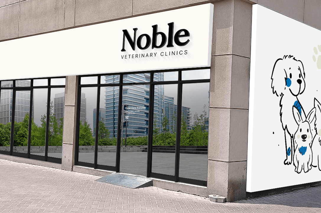 The front of Noble Veterinary Clinic in DIP, Dubai. Our vet clinic features glass doors and windows with reverse silhouettes of pets on the windows surrounding the doors.