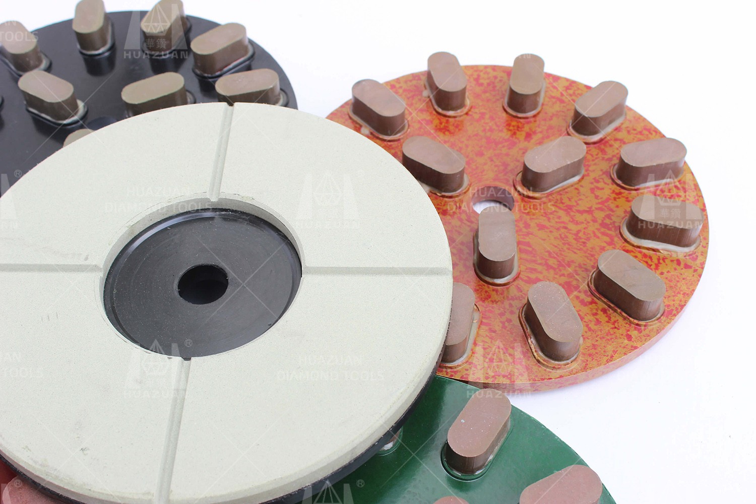 Various Metal/Resin Bond Grinding Discs in different colors and designs stacked together.