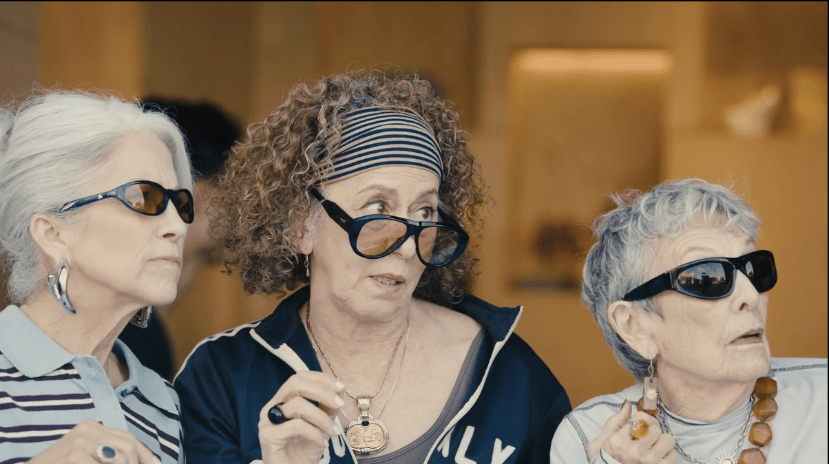 Three stylish older women wearing bold statement sunglasses