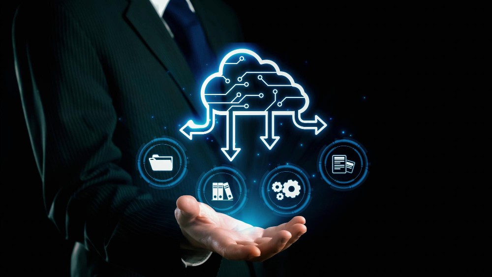 Aerial view of a winding road surrounded by dense green and yellow trees, showcasing nature’s vibrant colors.