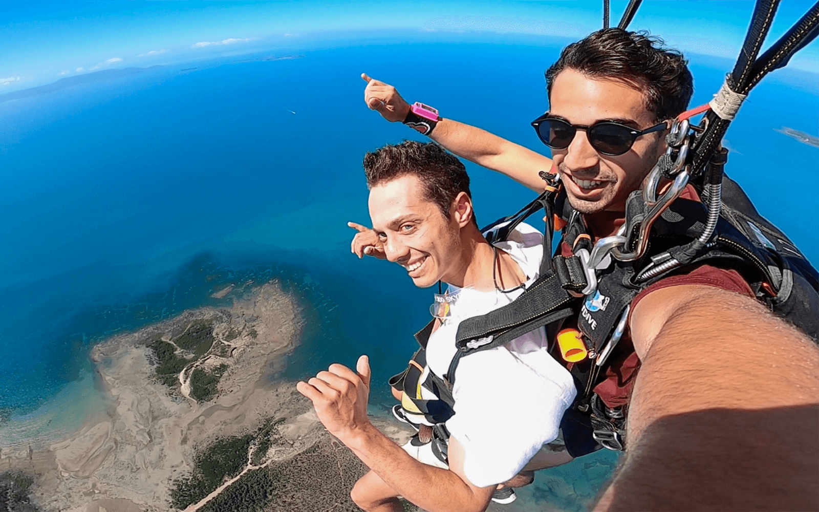 Tandem skydive over Airlie Beach with ocean view and beach landing.