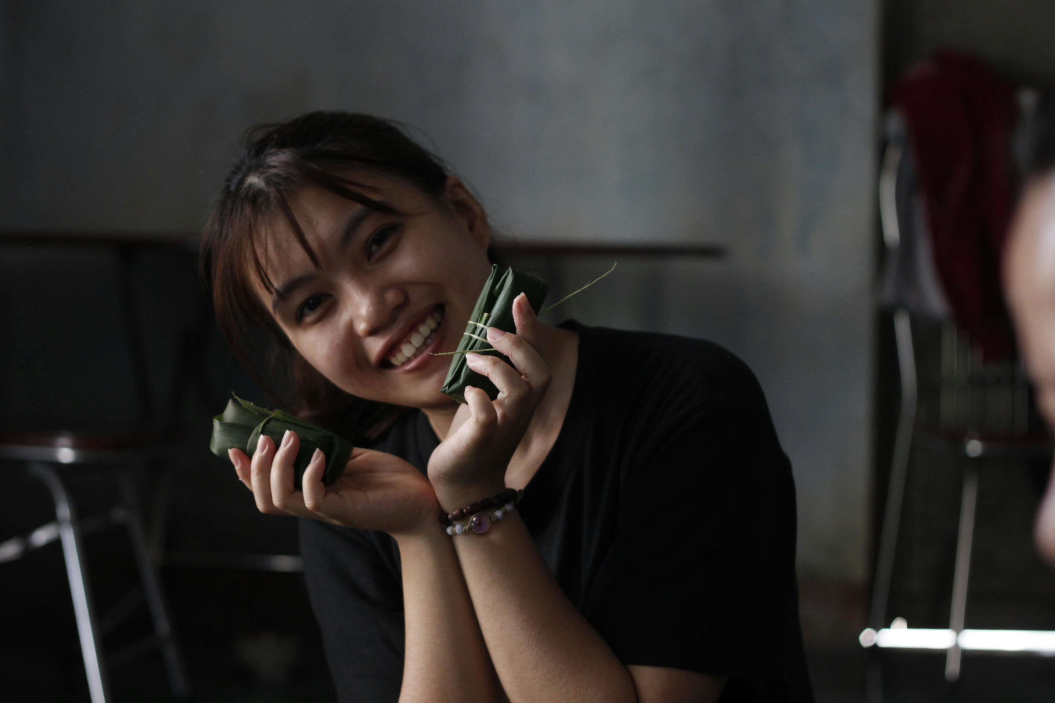 Smiling woman shows off delicious-looking food.
