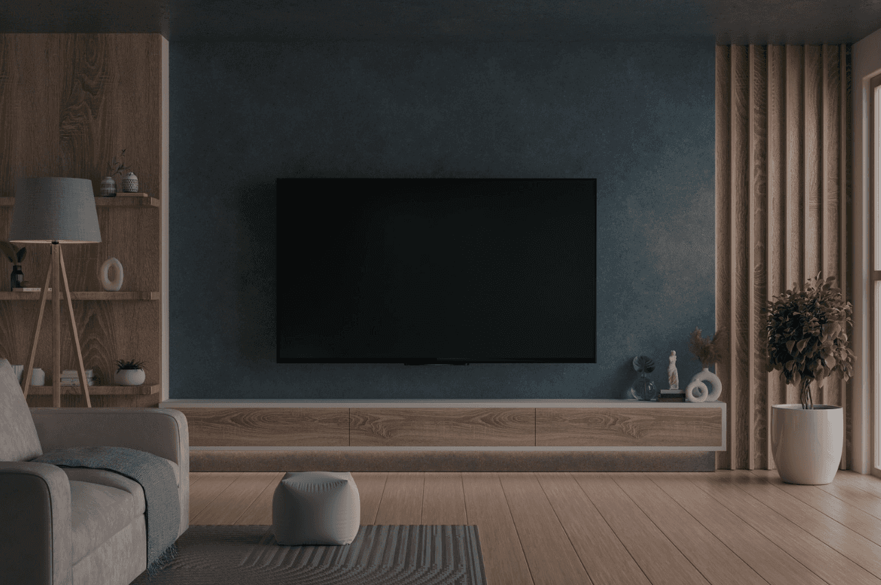 Three people sitting on a couch in a room looking at mobile devices