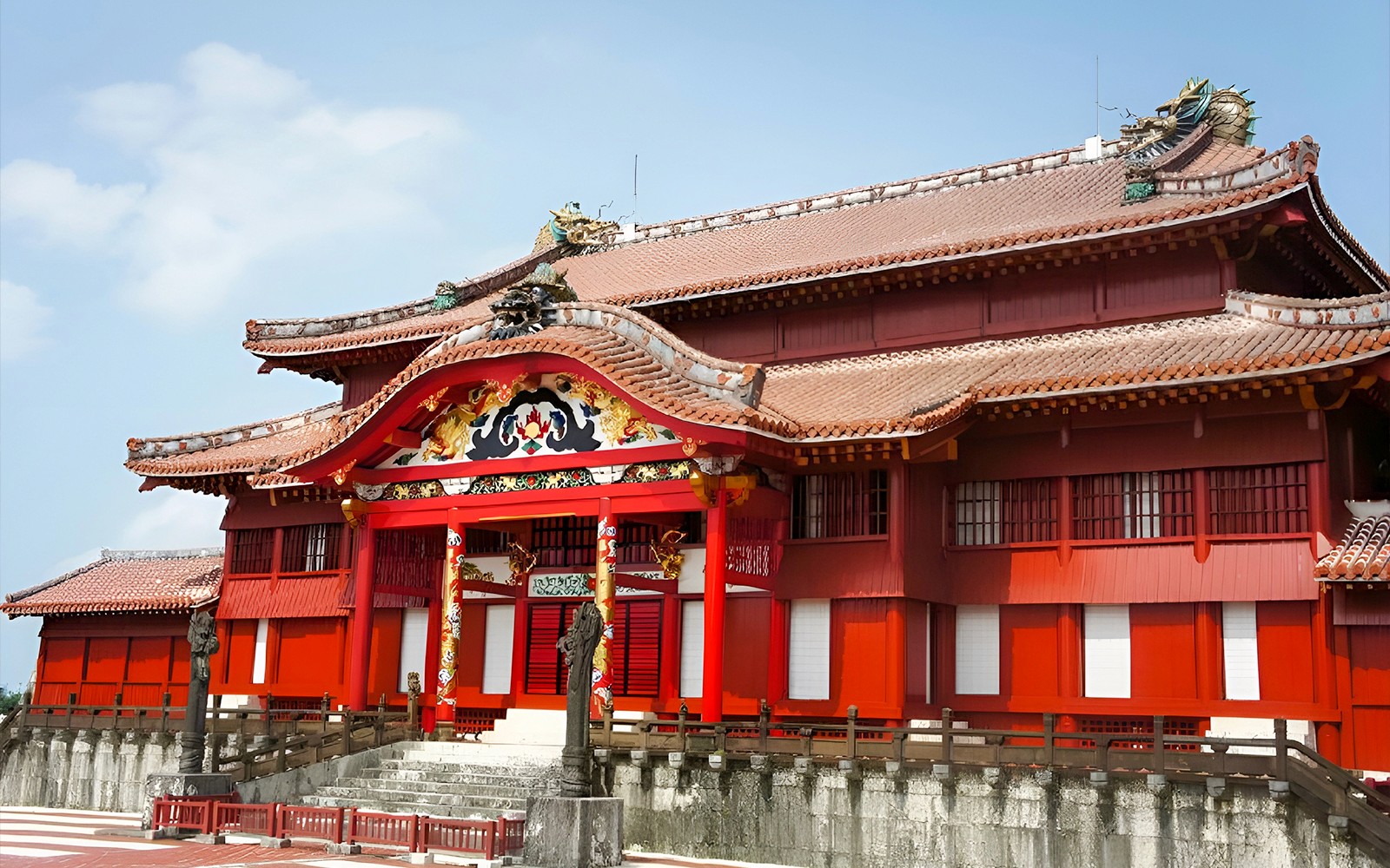 Shurijo Castle's vibrant red main hall in Okinawa, Japan.