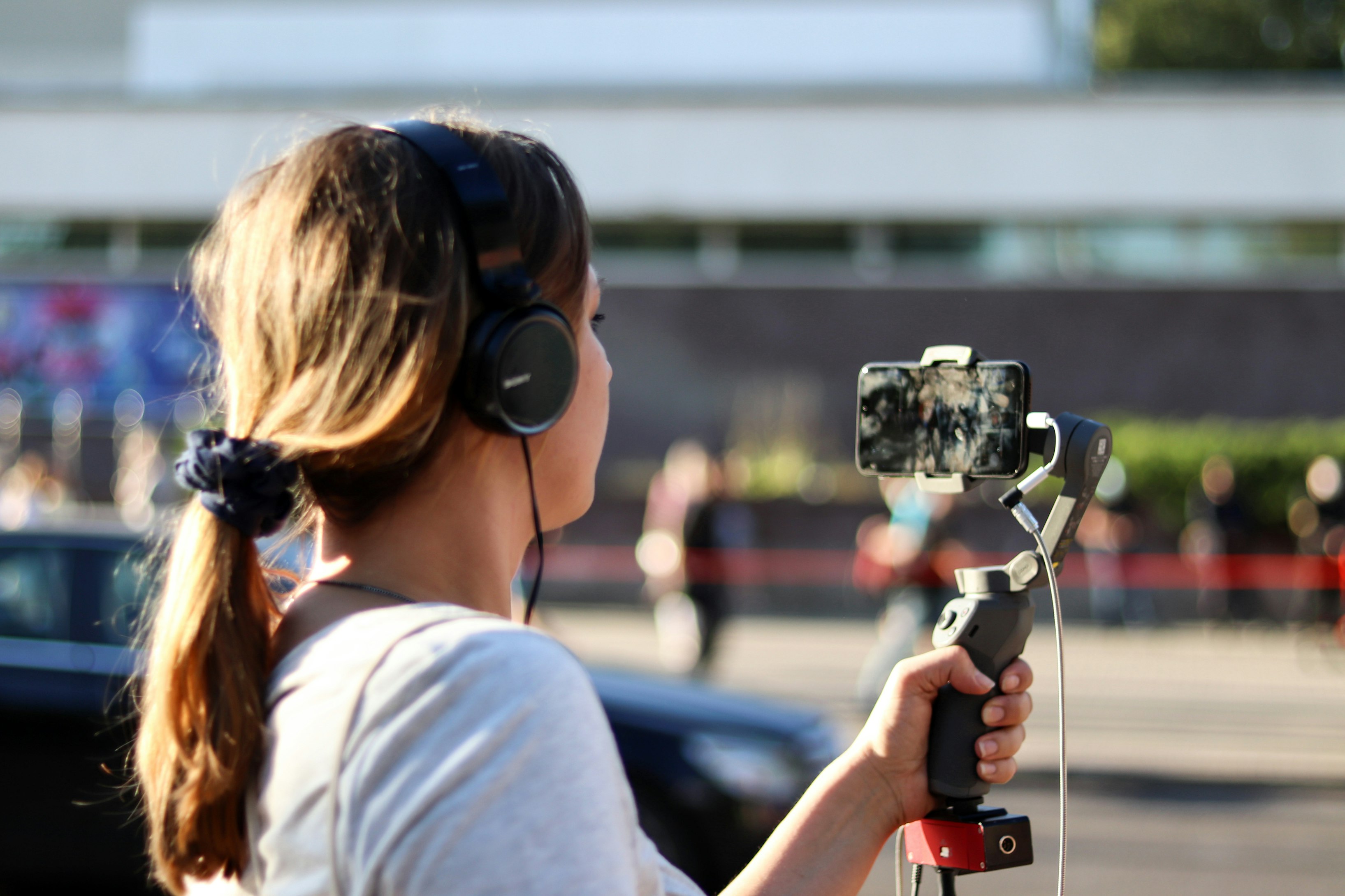 Creator filming video with a smartphone on a handheld stabilizer