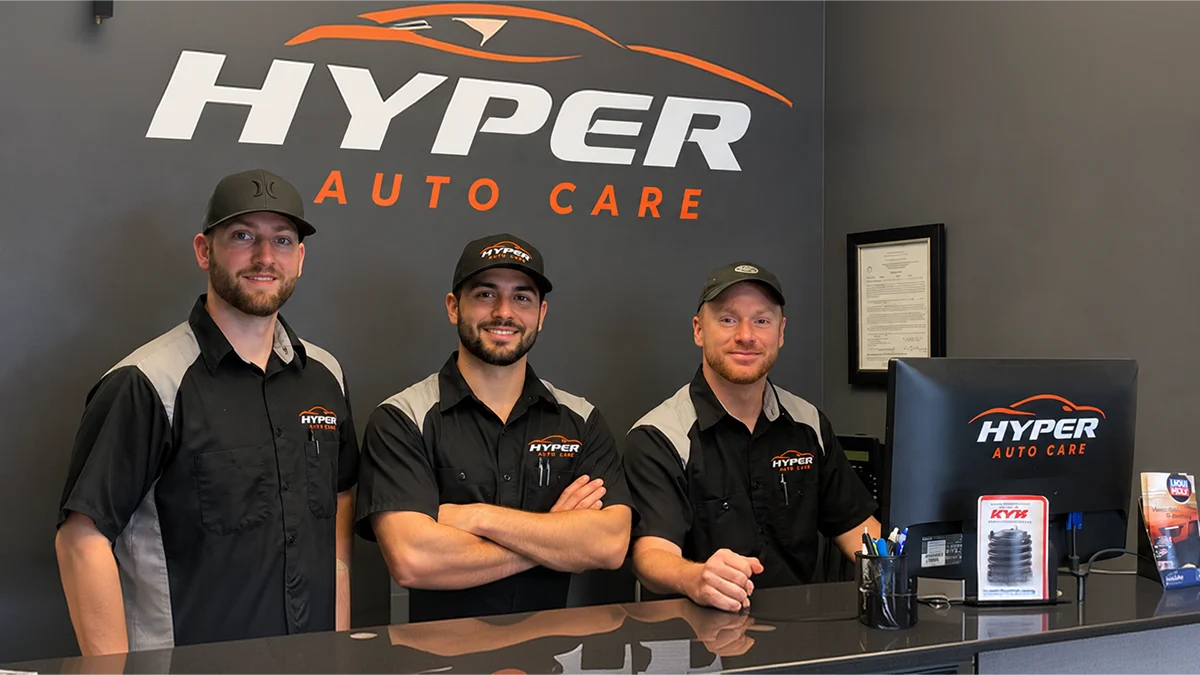 Three HyperAuto Care team members behind the reception counter