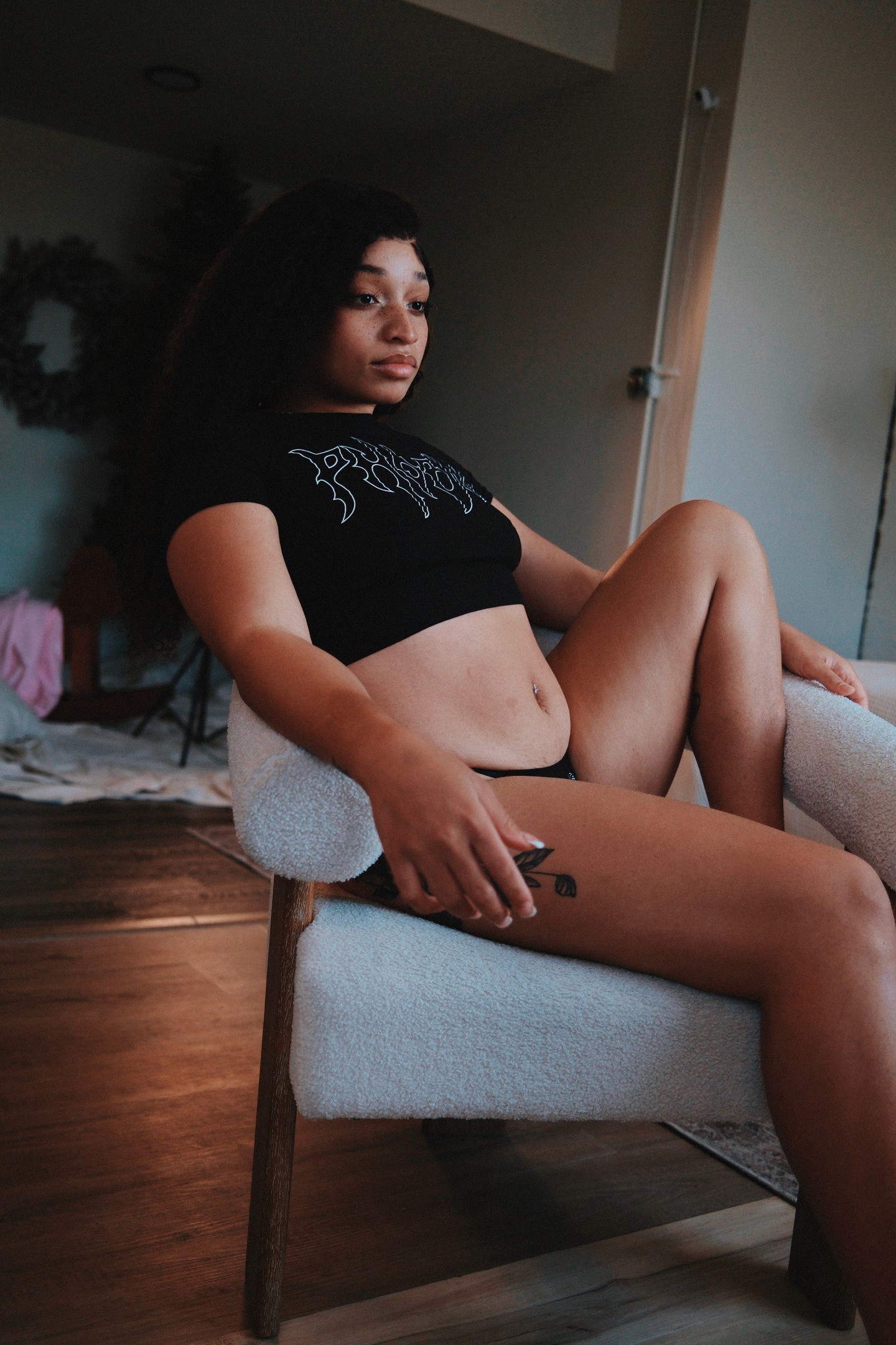 photo of girl posing with a cozy by mari crop top that say's phobia on the front