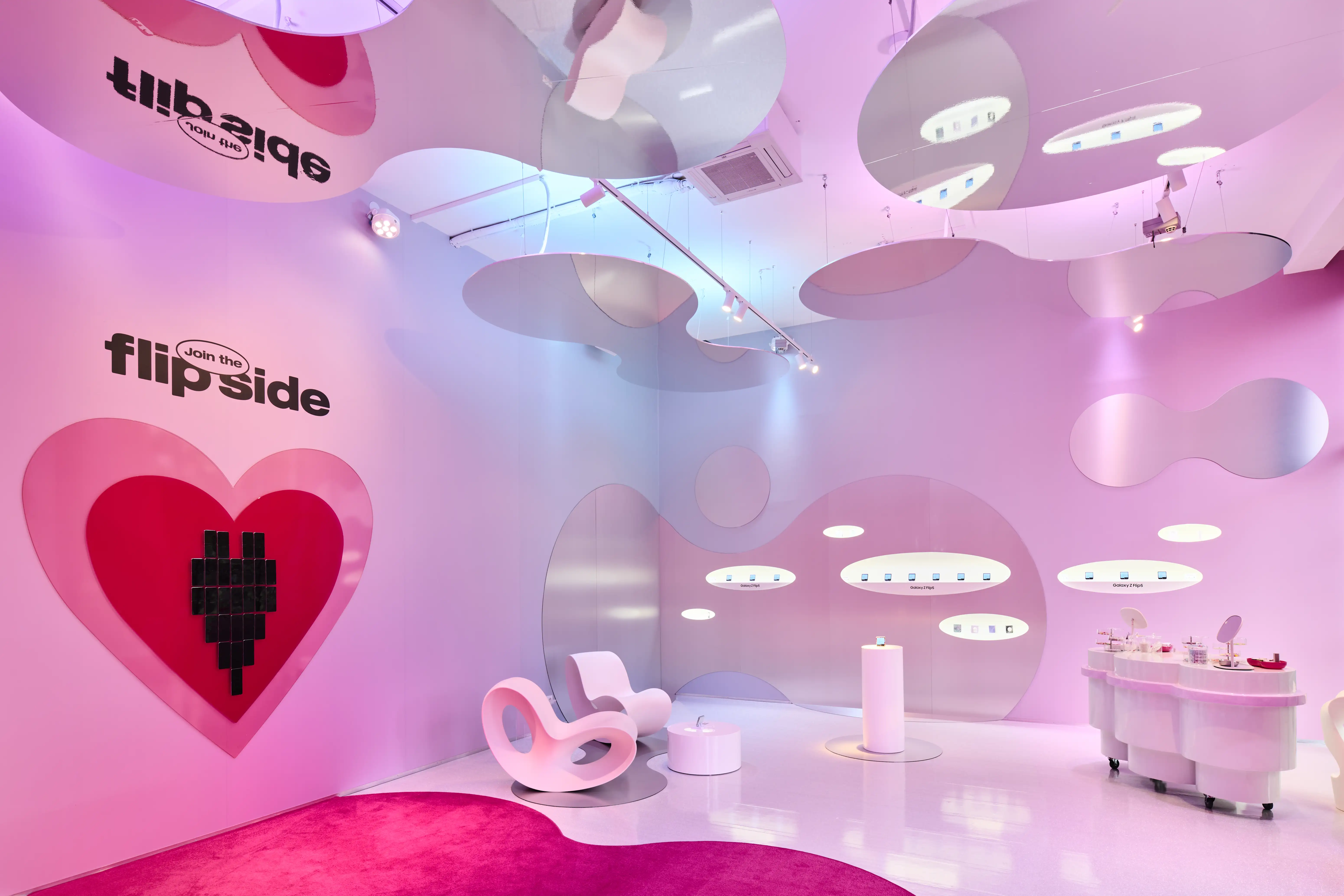 Pink Flipside pop-up by Highsnobiety x Samsung with heart graphic, organic cloud ceiling panels and white designer furniture.