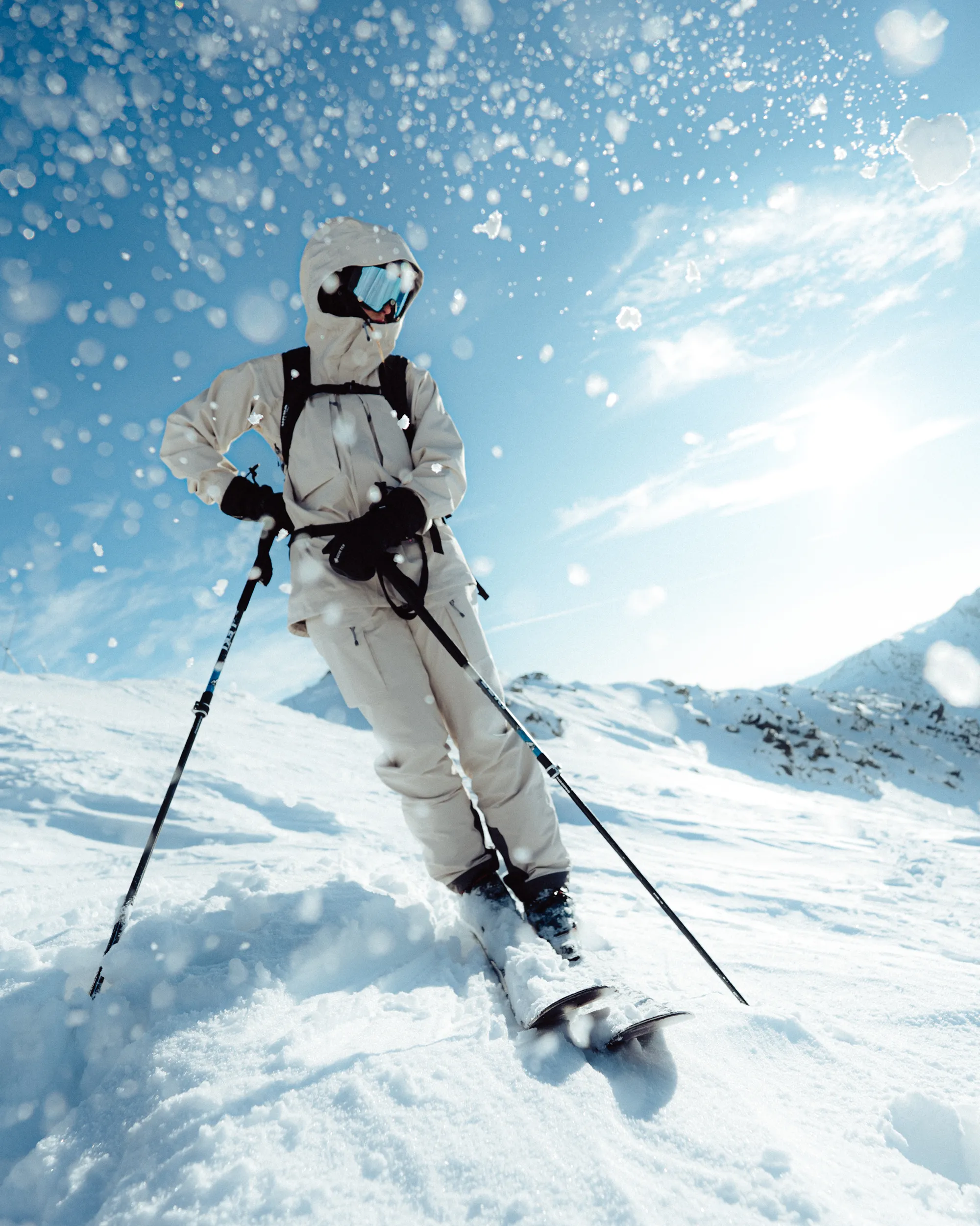 dynamic, snowy full body portrait of a skier in the snow.
