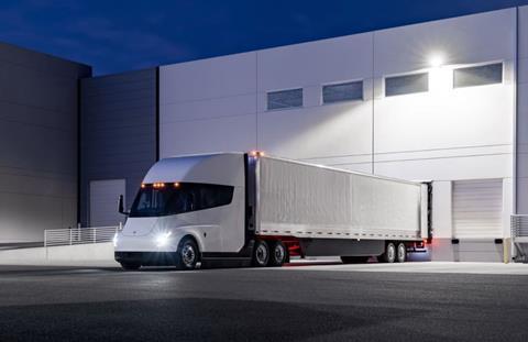 Electric truck cruising on a highway as part of a logistics fleet focused on reducing carbon emissions