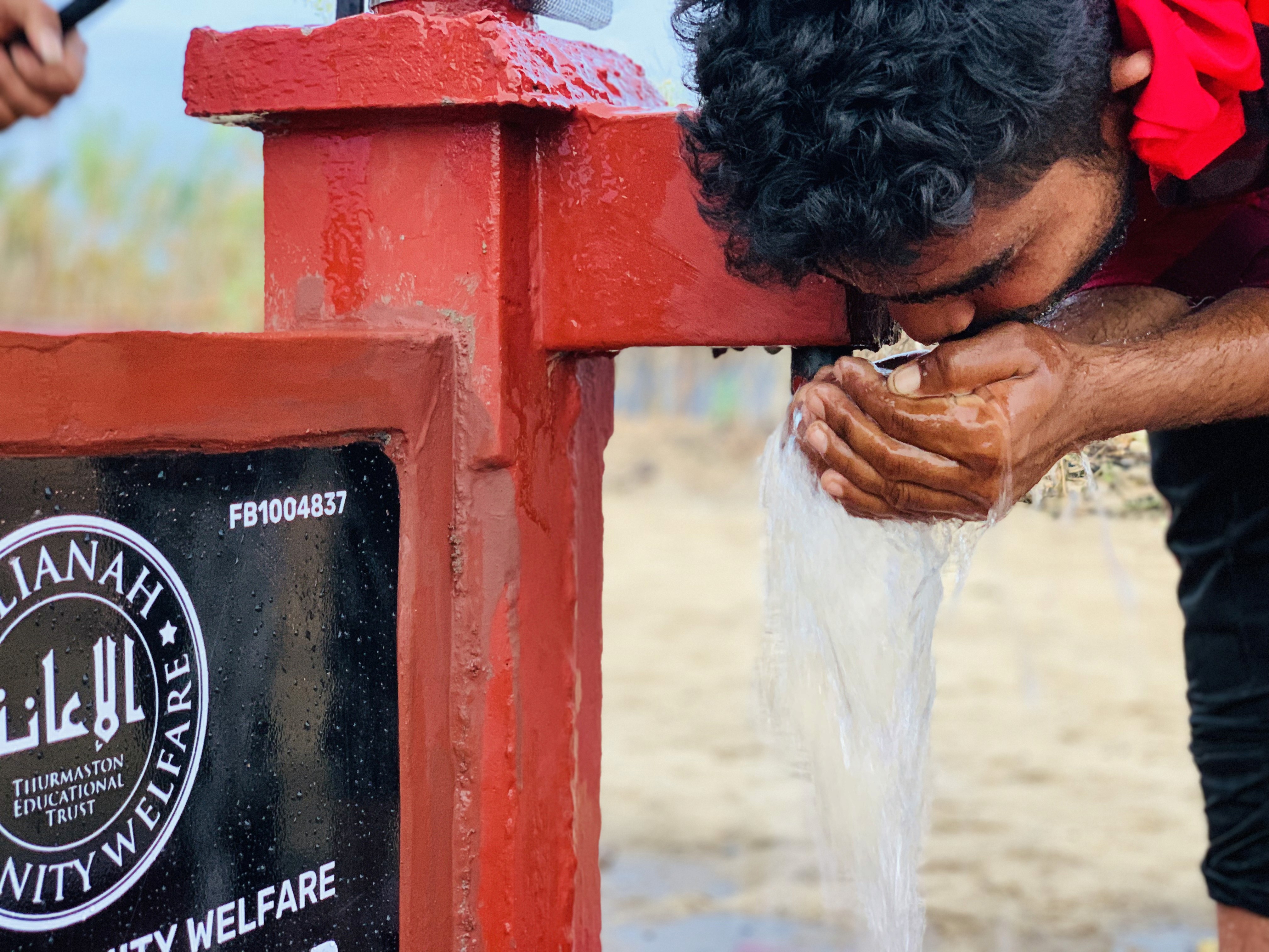 man stranding on straight road photo during daytime