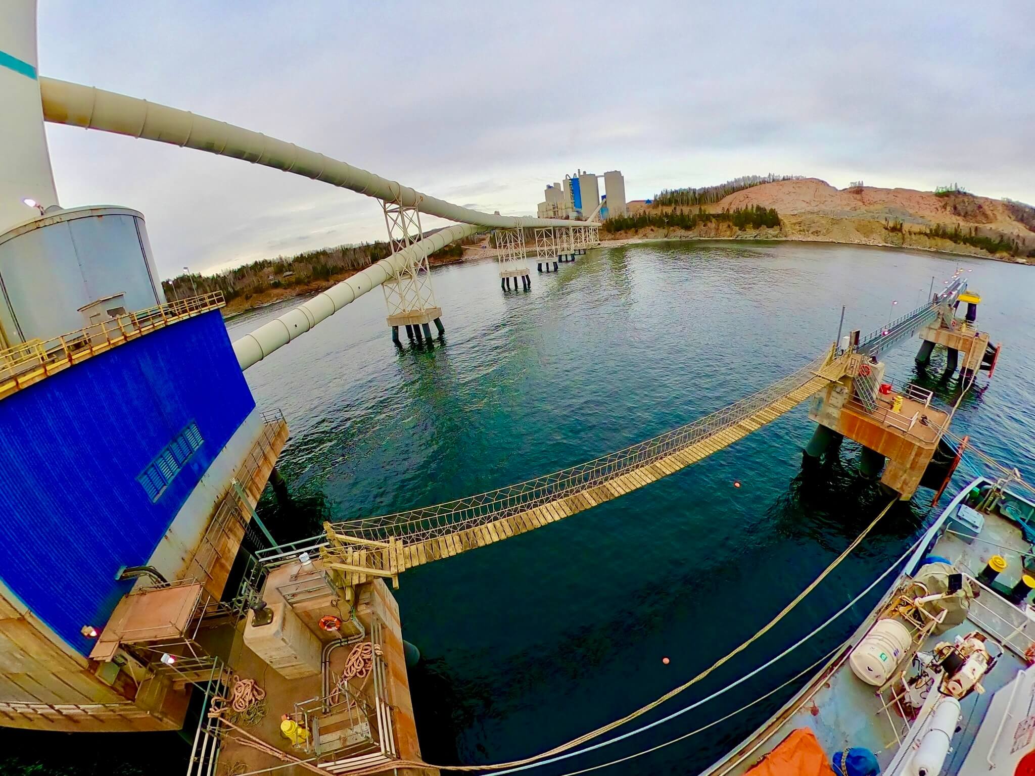 Construction workers building a wooden deck frame in a garden.