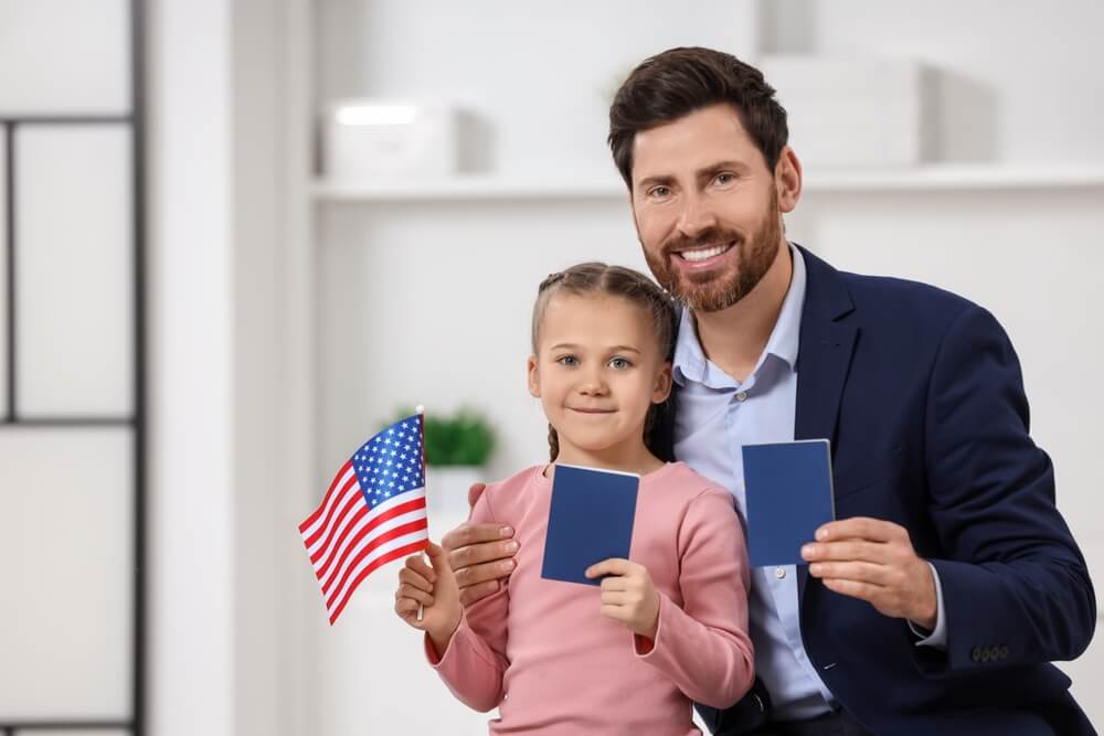child and father holding US passports