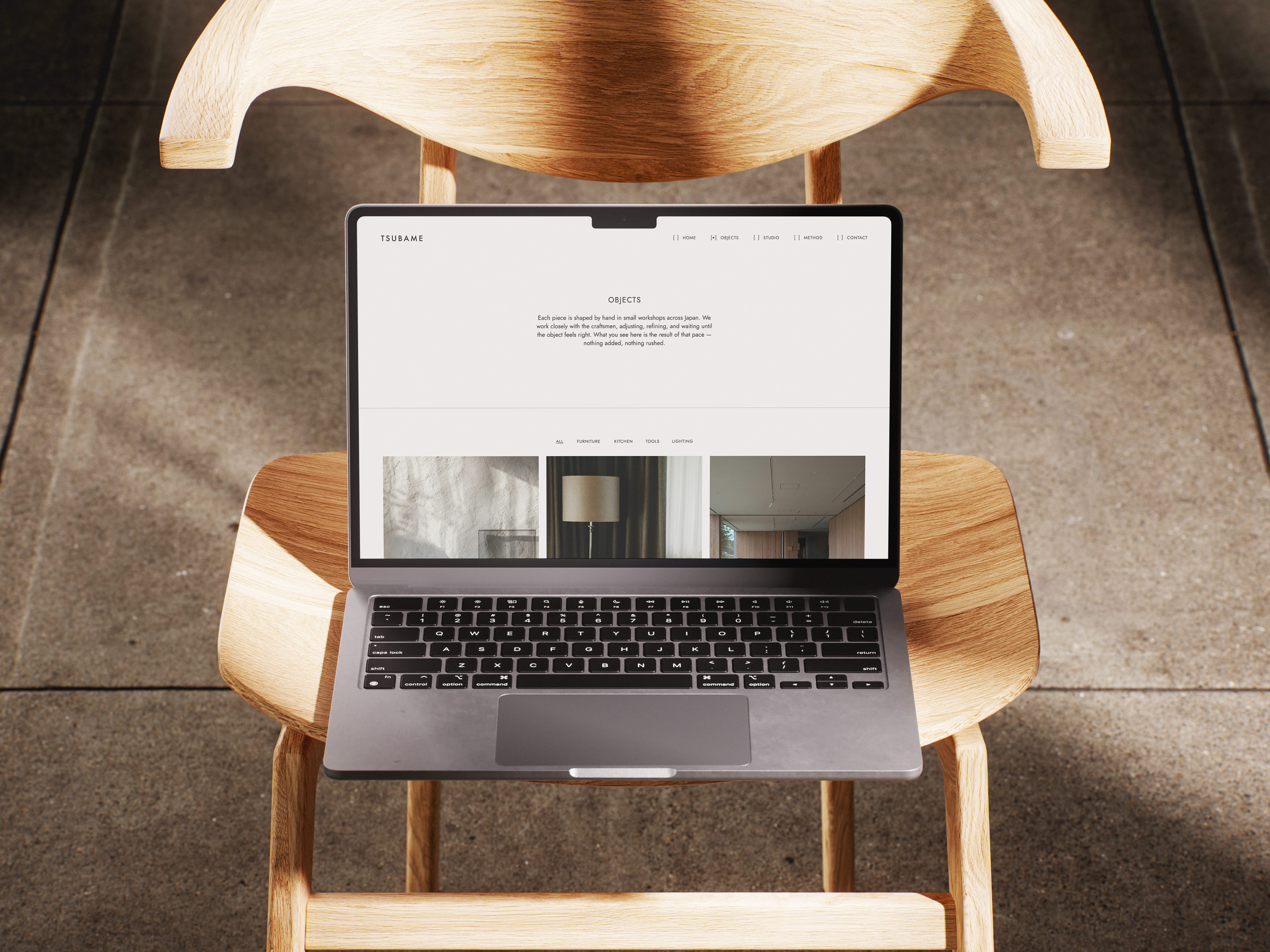 Macbook on a chair displaying the Tsubame website