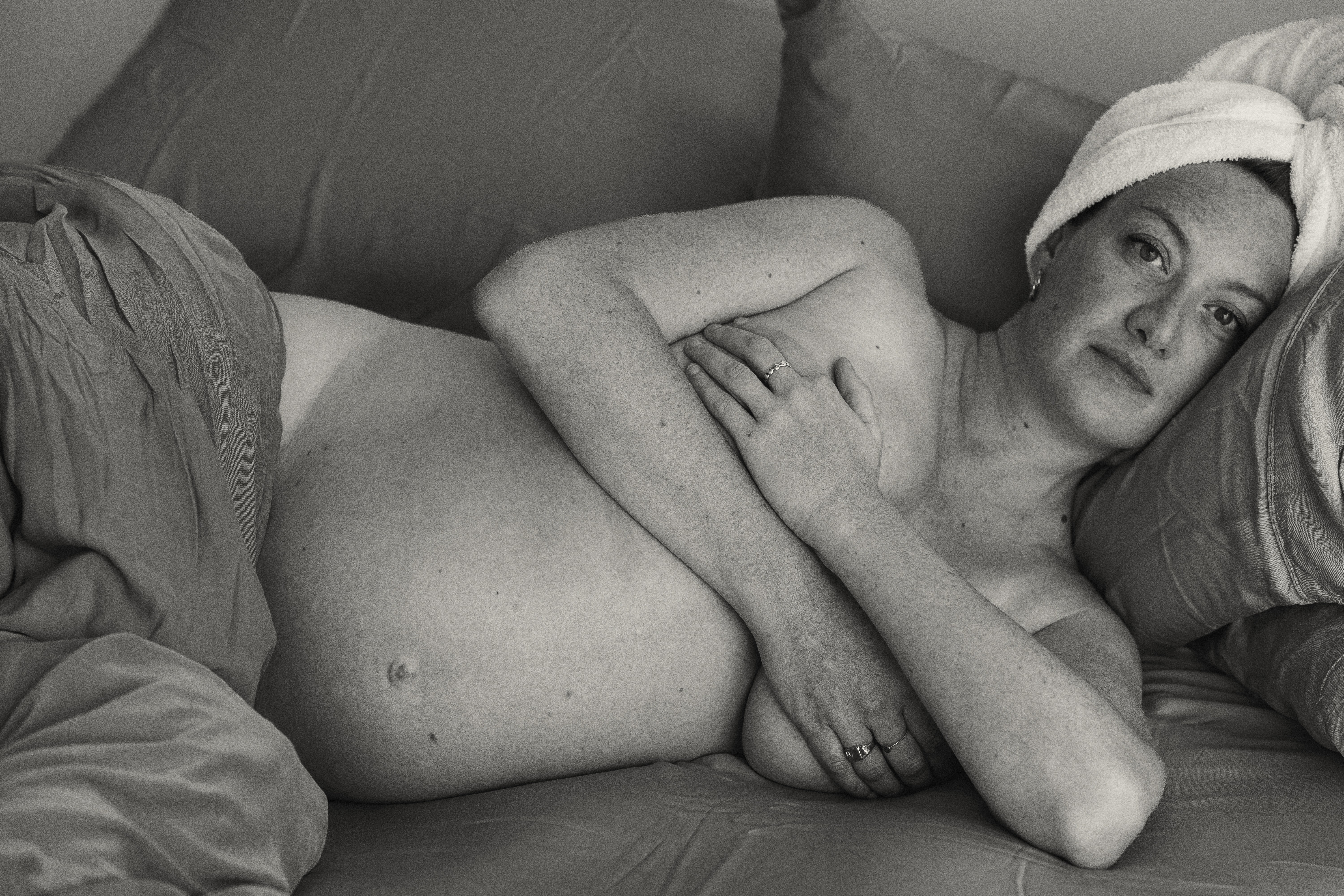 Pregnant woman lying comfortably while receiving a gentle spa treatment.