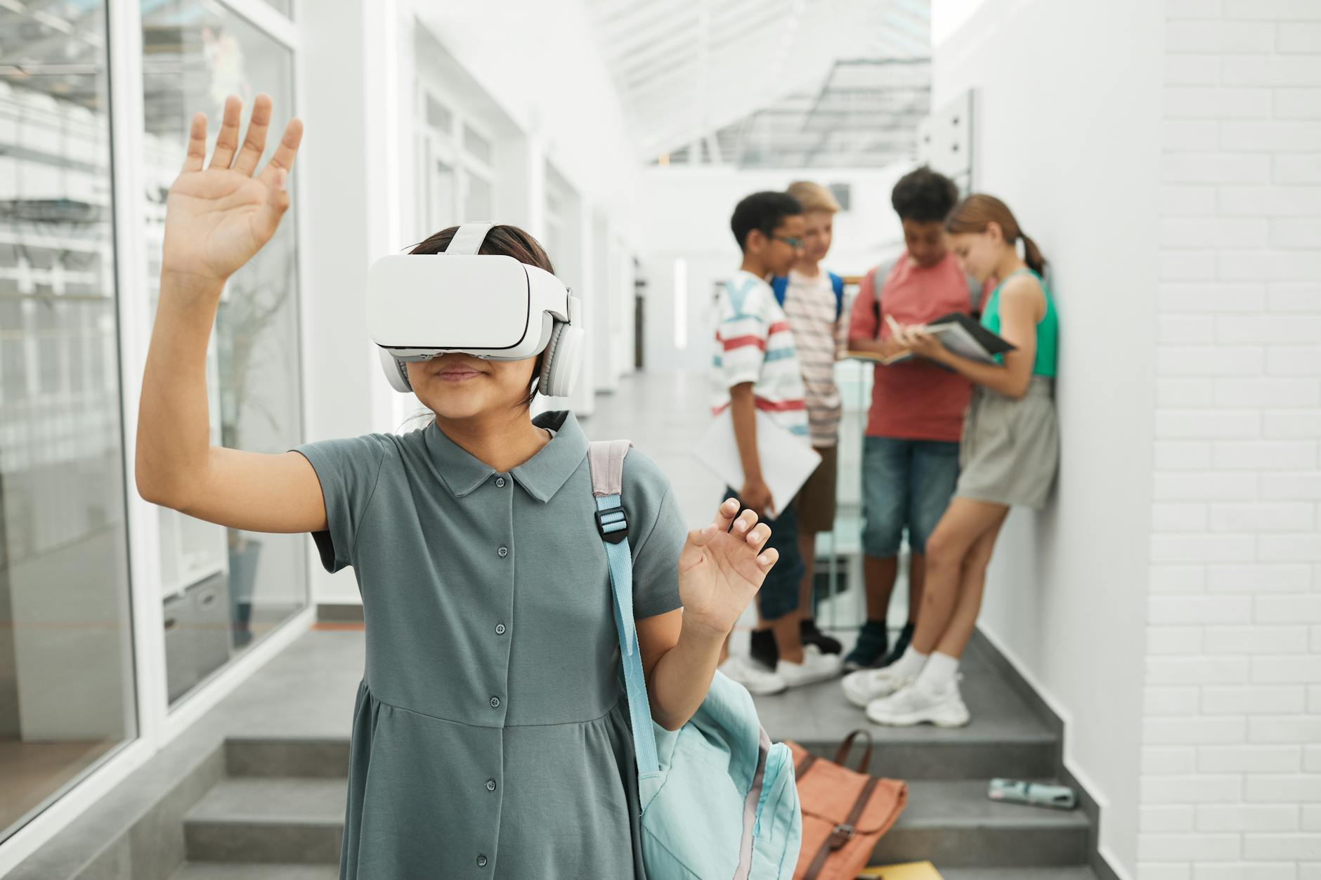 A high school student wearing a VR headset while exploring a digital 3D model of a human heart in a science lab.