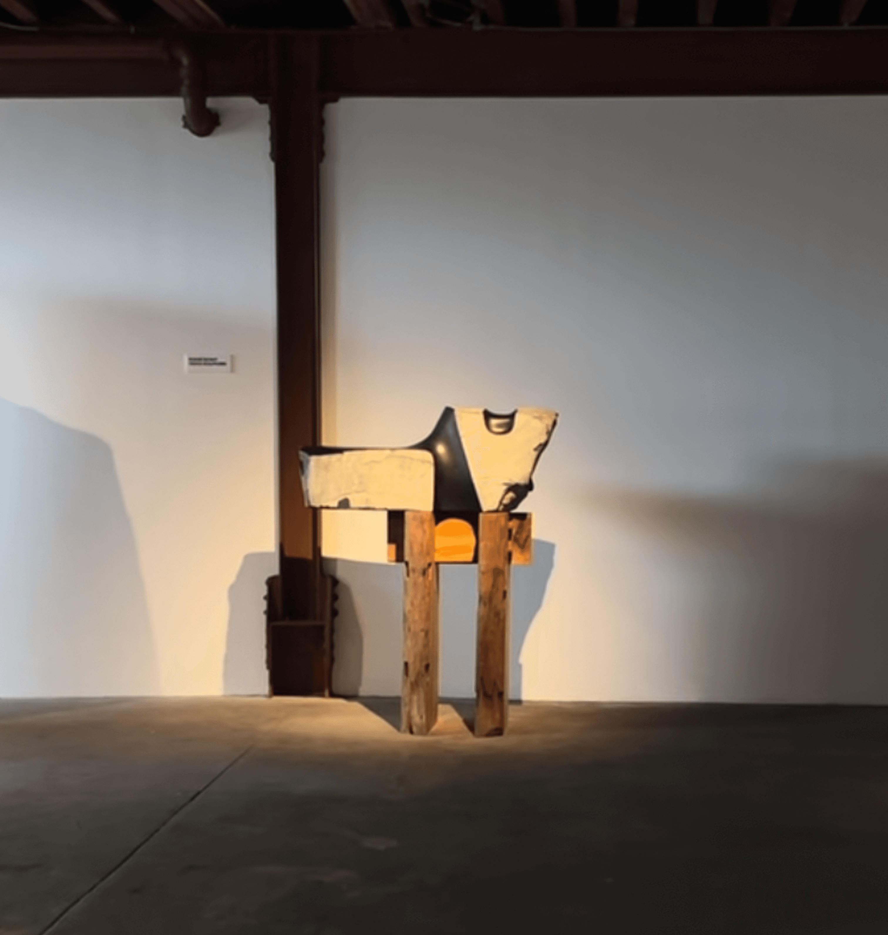 Noguchi sculpture combining stone and black lacquer on wooden beams under dramatic lighting, The Noguchi Museum Queens