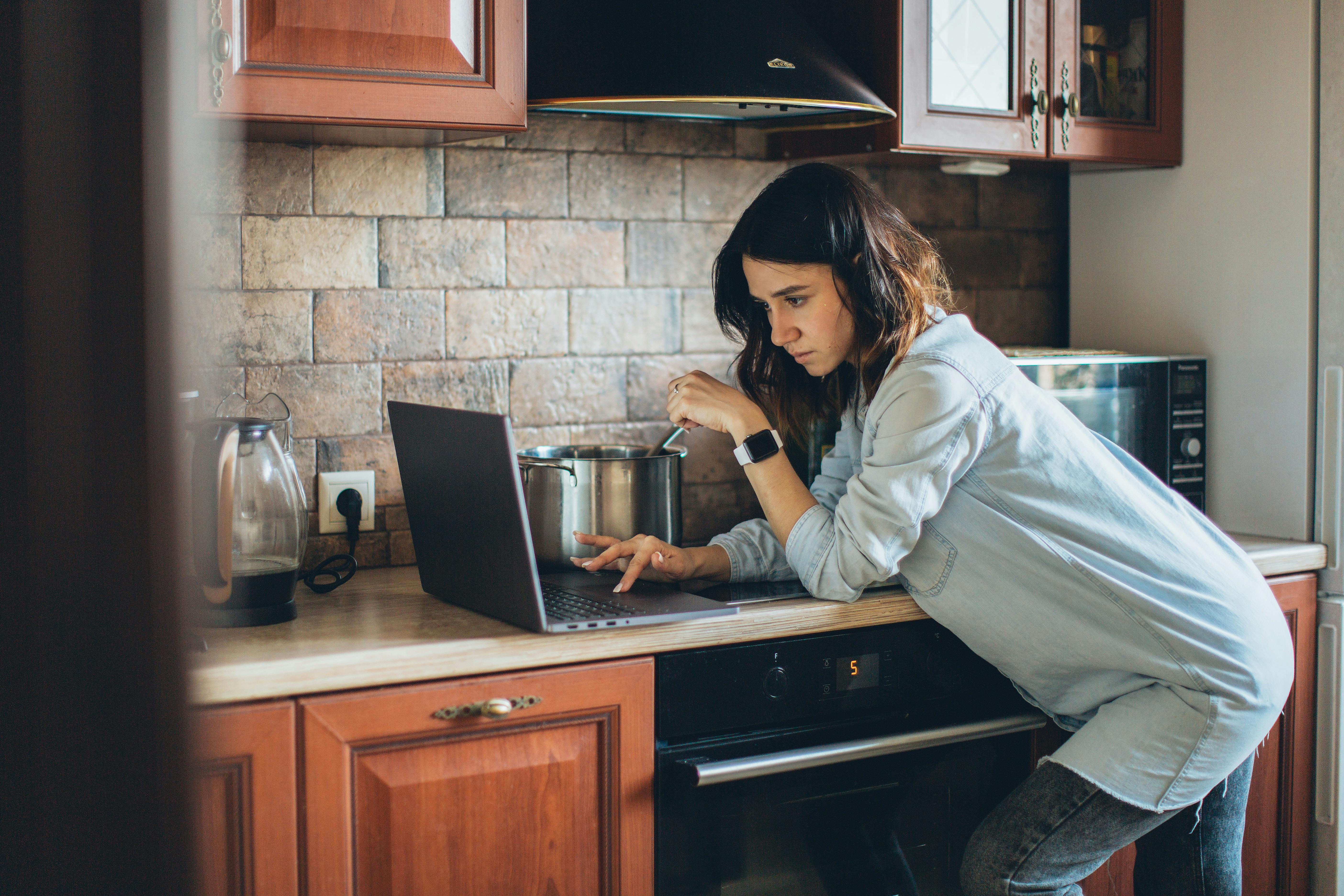 woman holding a phone and man looking at the phone. both are smiling
