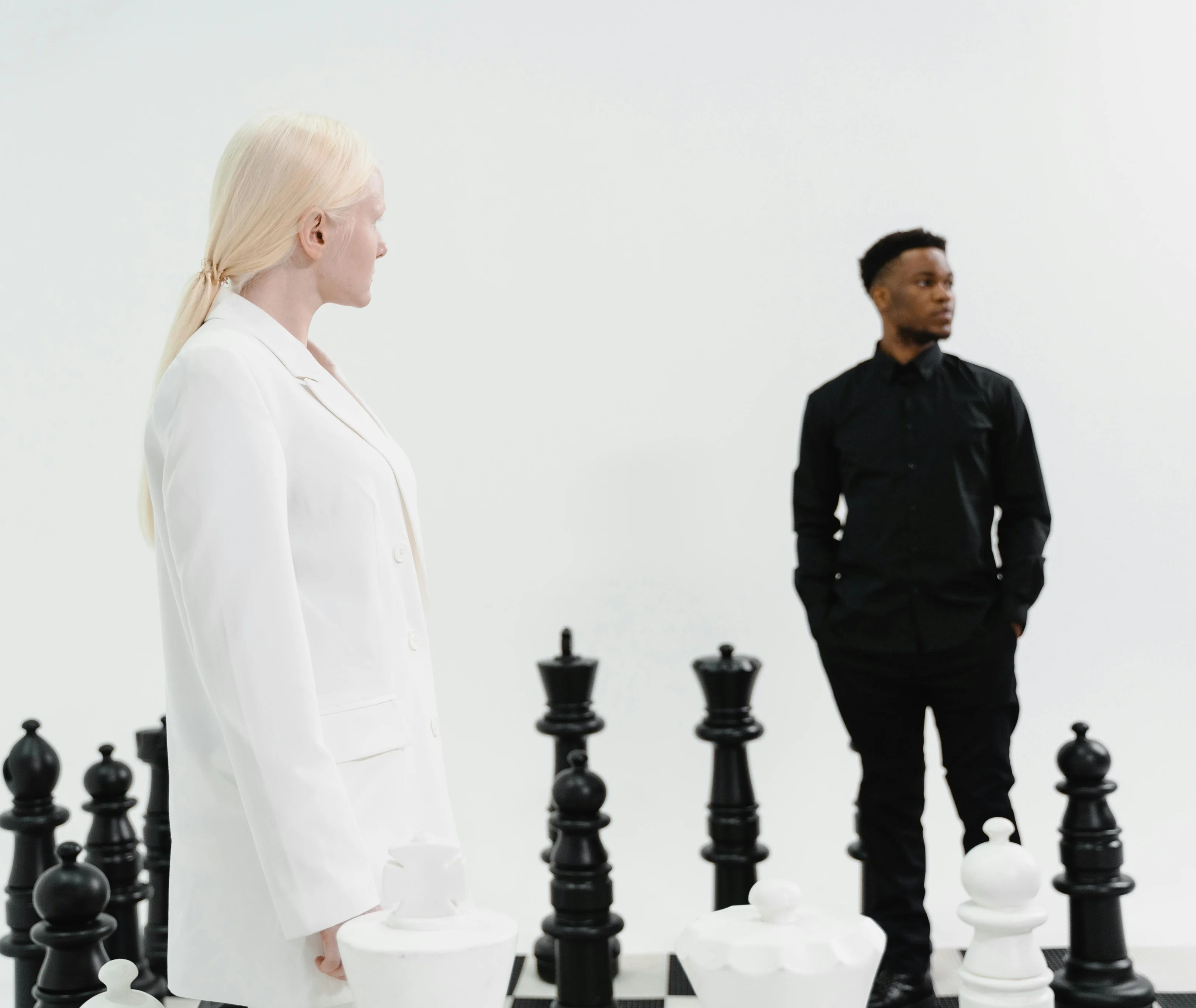 Nathan Mitchell & Lea Cole standing on chess board