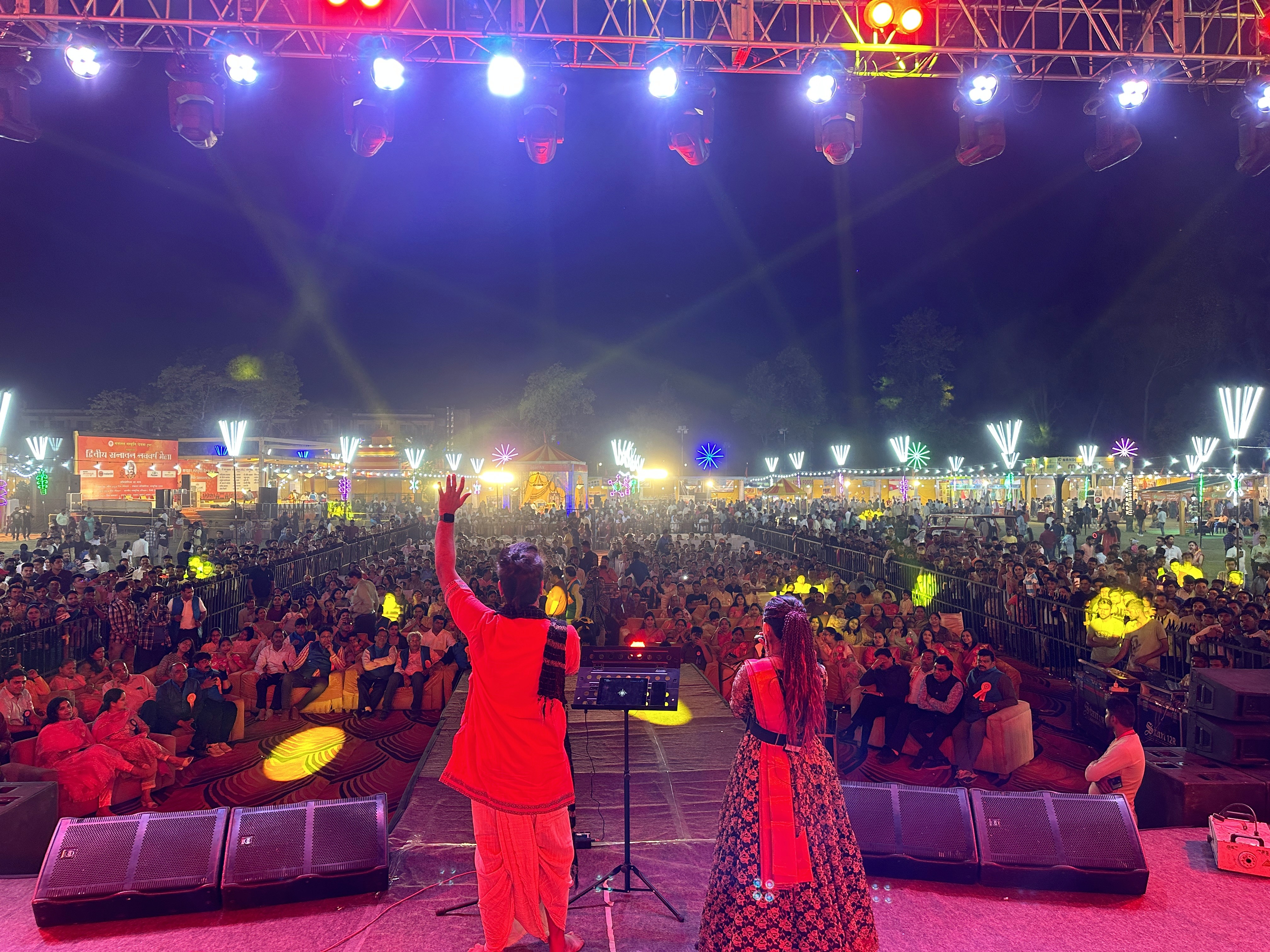 Performer under spotlight on dark stage