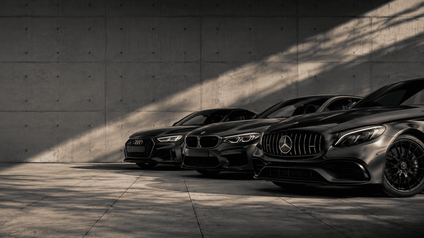 Sleek, dark gray sports car with open doors, red brake calipers, parked indoors, bathed in sunlight.